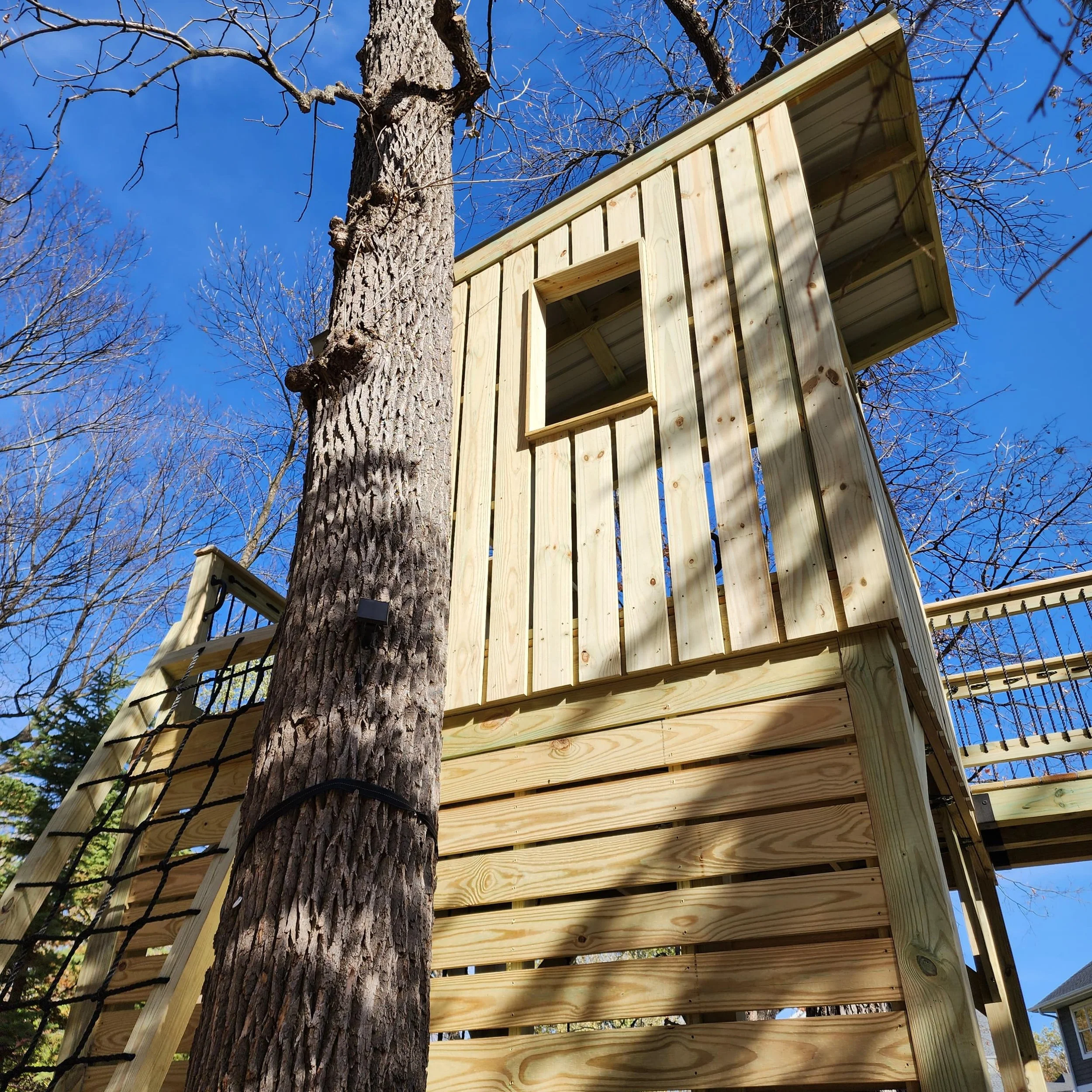 custom tree fort clubhouse with modern window