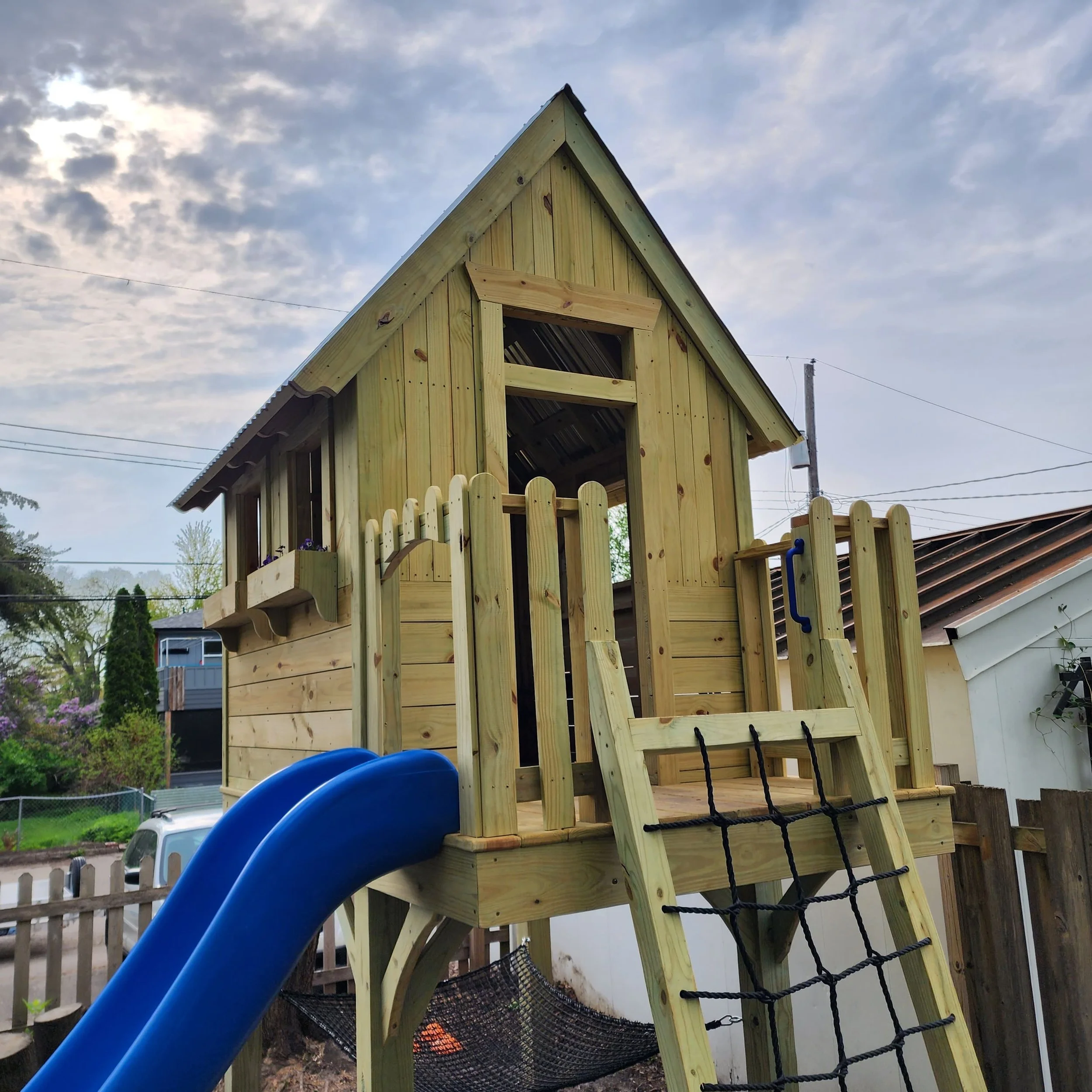 custom wood play structure with cargo net
