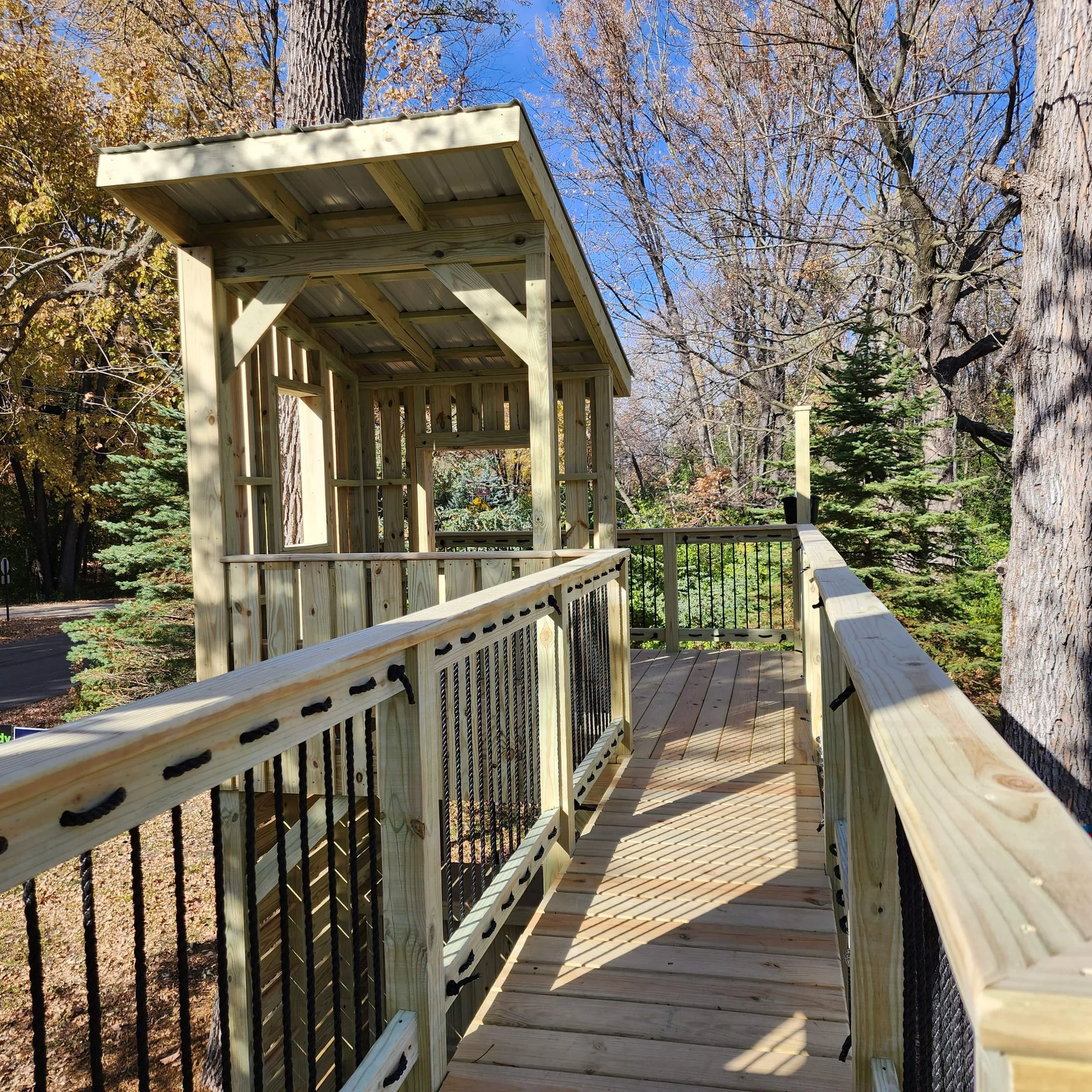 custom tree fort bridge looking at a clubhouse