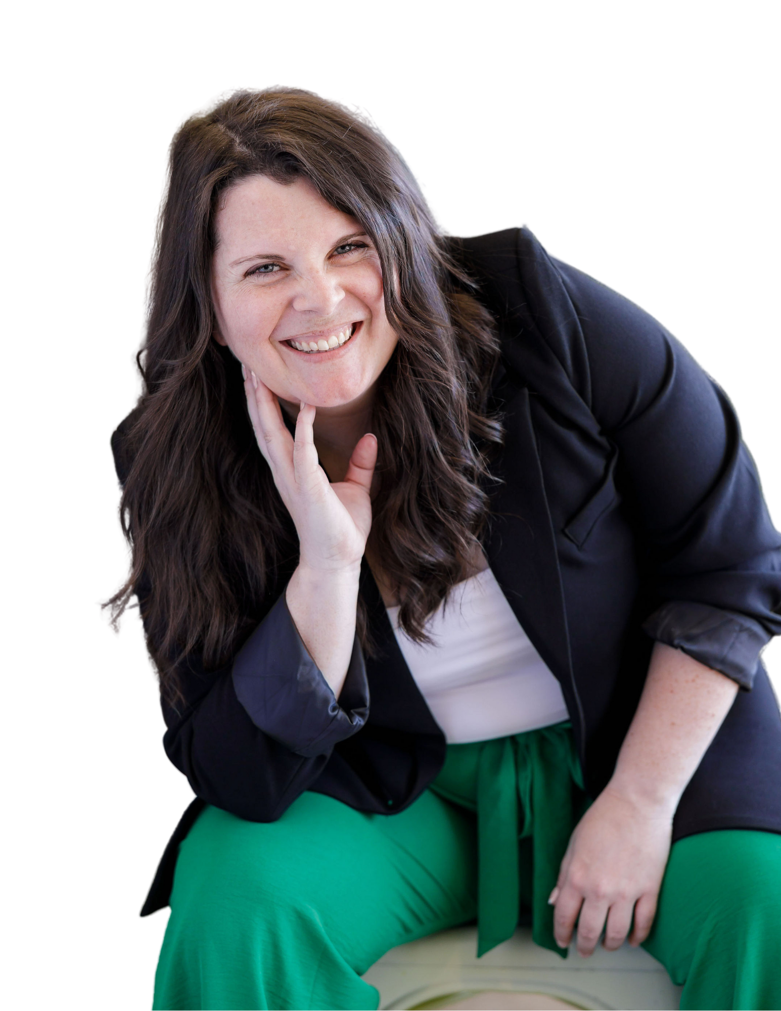 A woman with long brown hair and a bright smile, wearing a black jacket, white top, and green pants, sitting and posing with her hand near her face. Business systems architecture diagram for sustainable growth