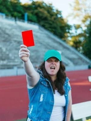 Ellyn holding up a red card