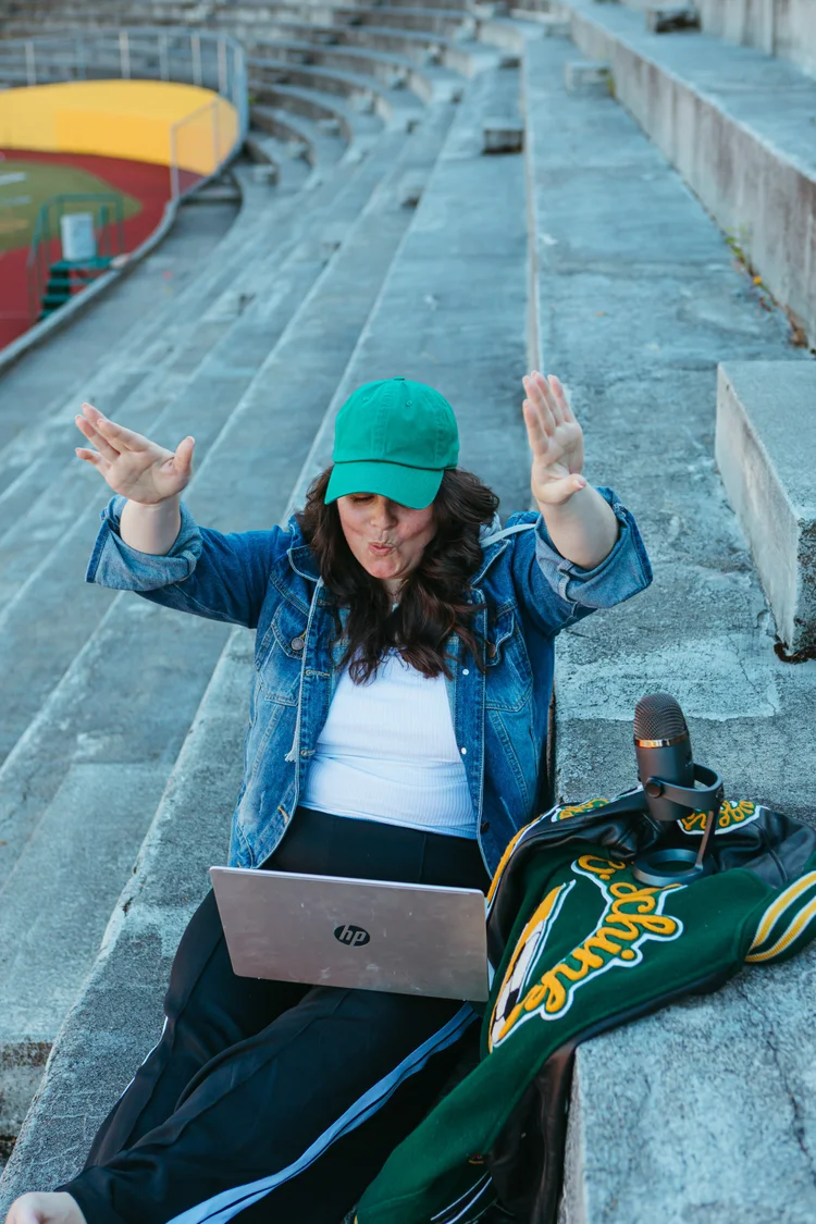 Ellyn on the bleachers with her laptop