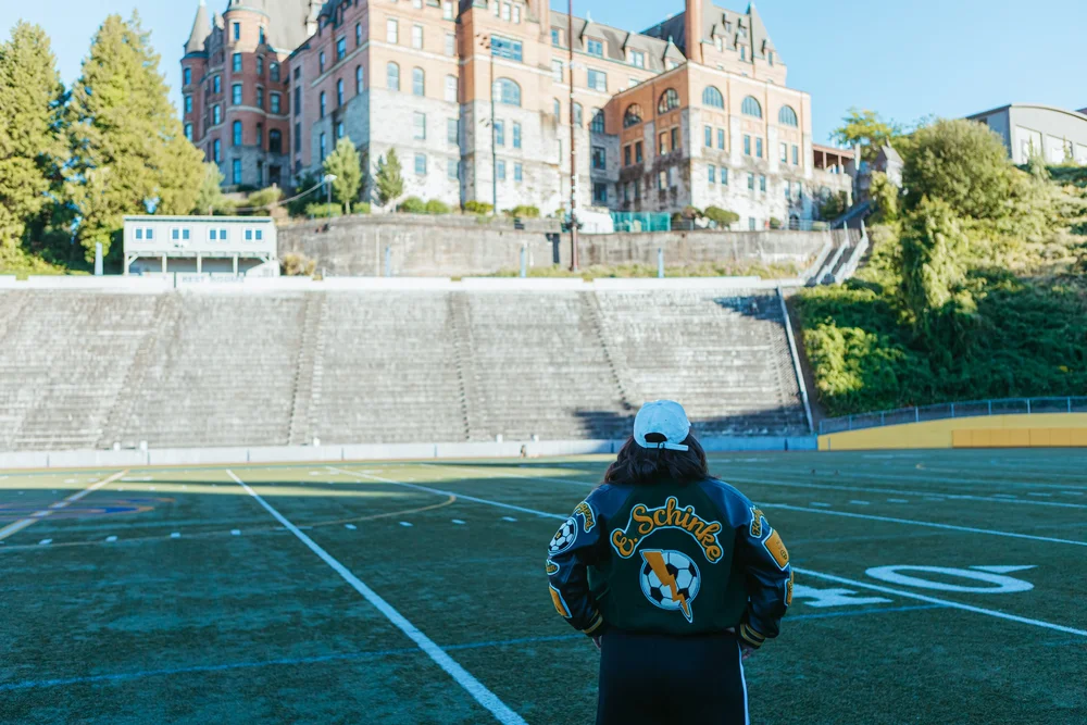 Ellyn from behind, looking out across the stadium field
