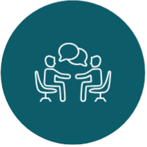 Two people sitting at a table with speech bubbles above them, indicating conversation.