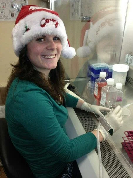 Ellyn in the research lab wearing a Santa hat