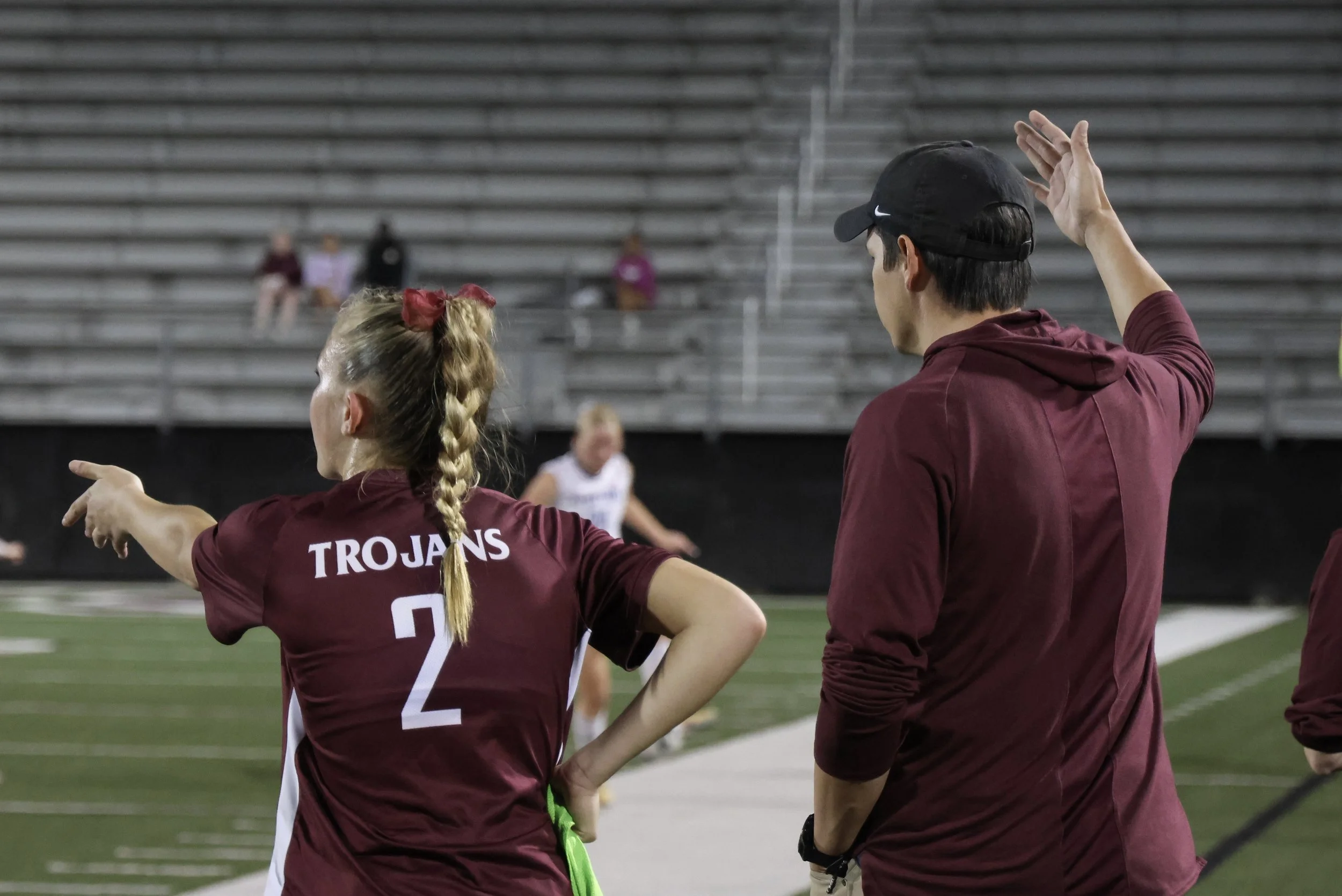 Coach and player on sidelines