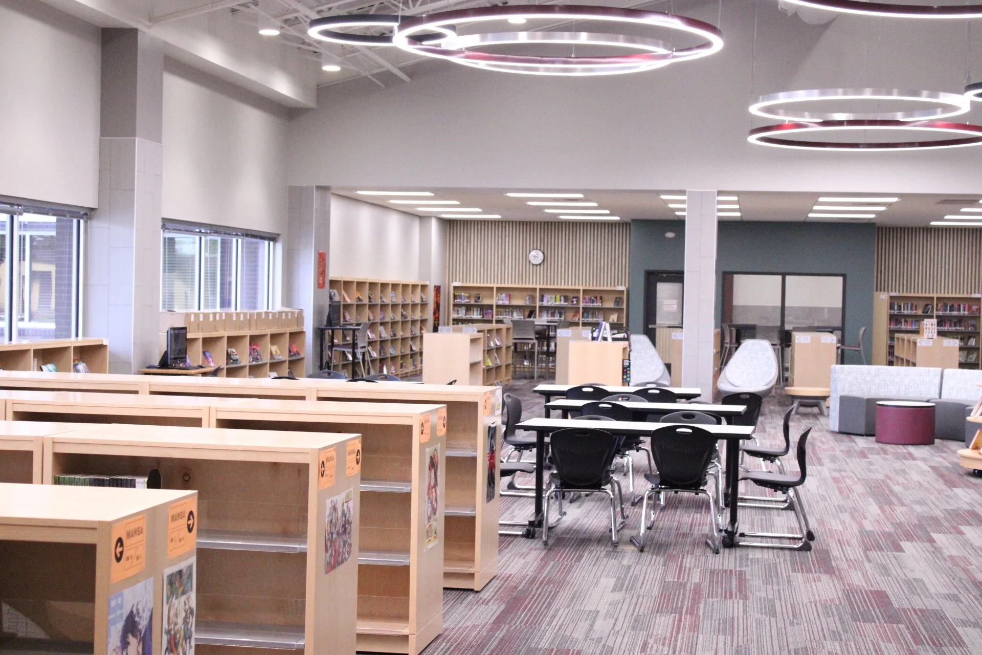 A picture of the FA library, There are shelves filled with books and tables for collaboration