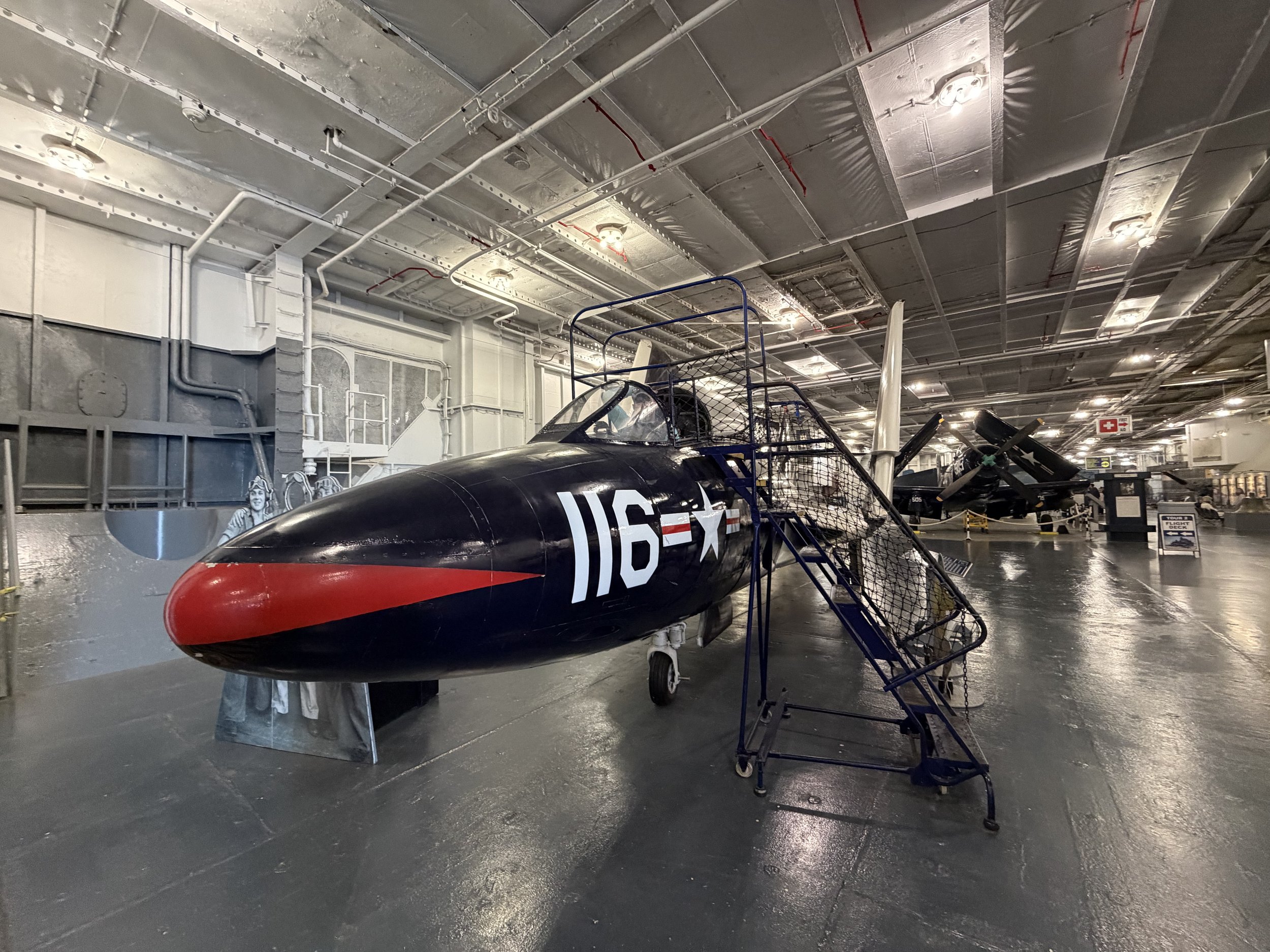 Plane sitting inside Aircraft carrier.