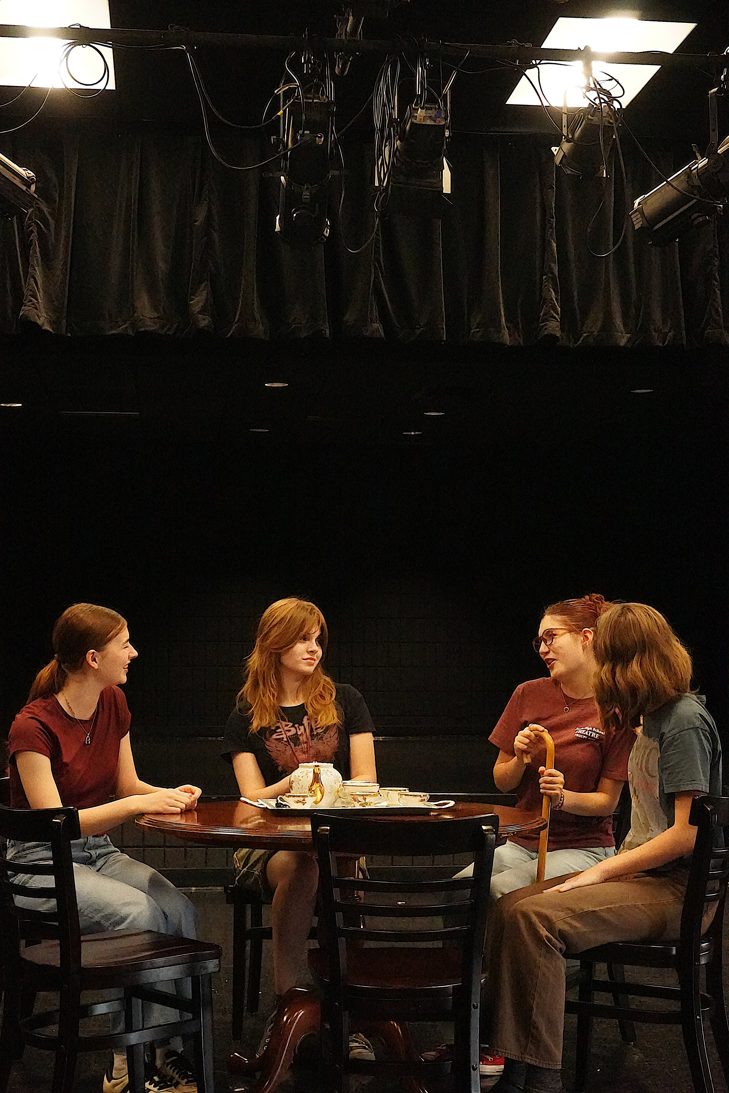 four women sit at a table