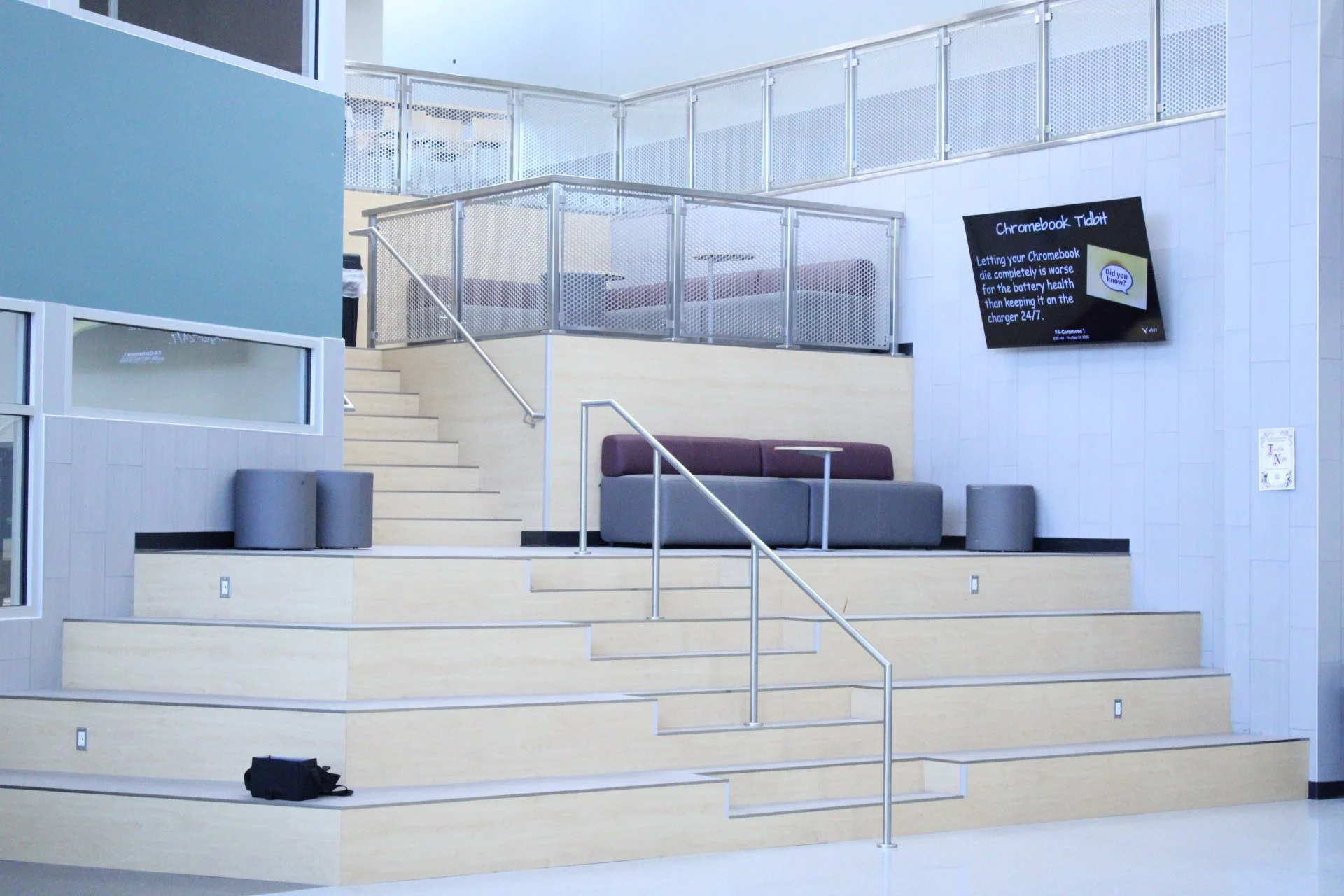 A picture of the new common area with chairs and stairs and seating