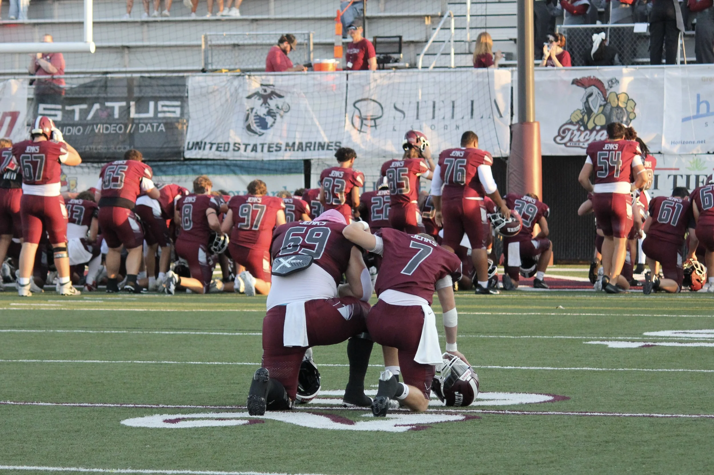 Players praying together before game.