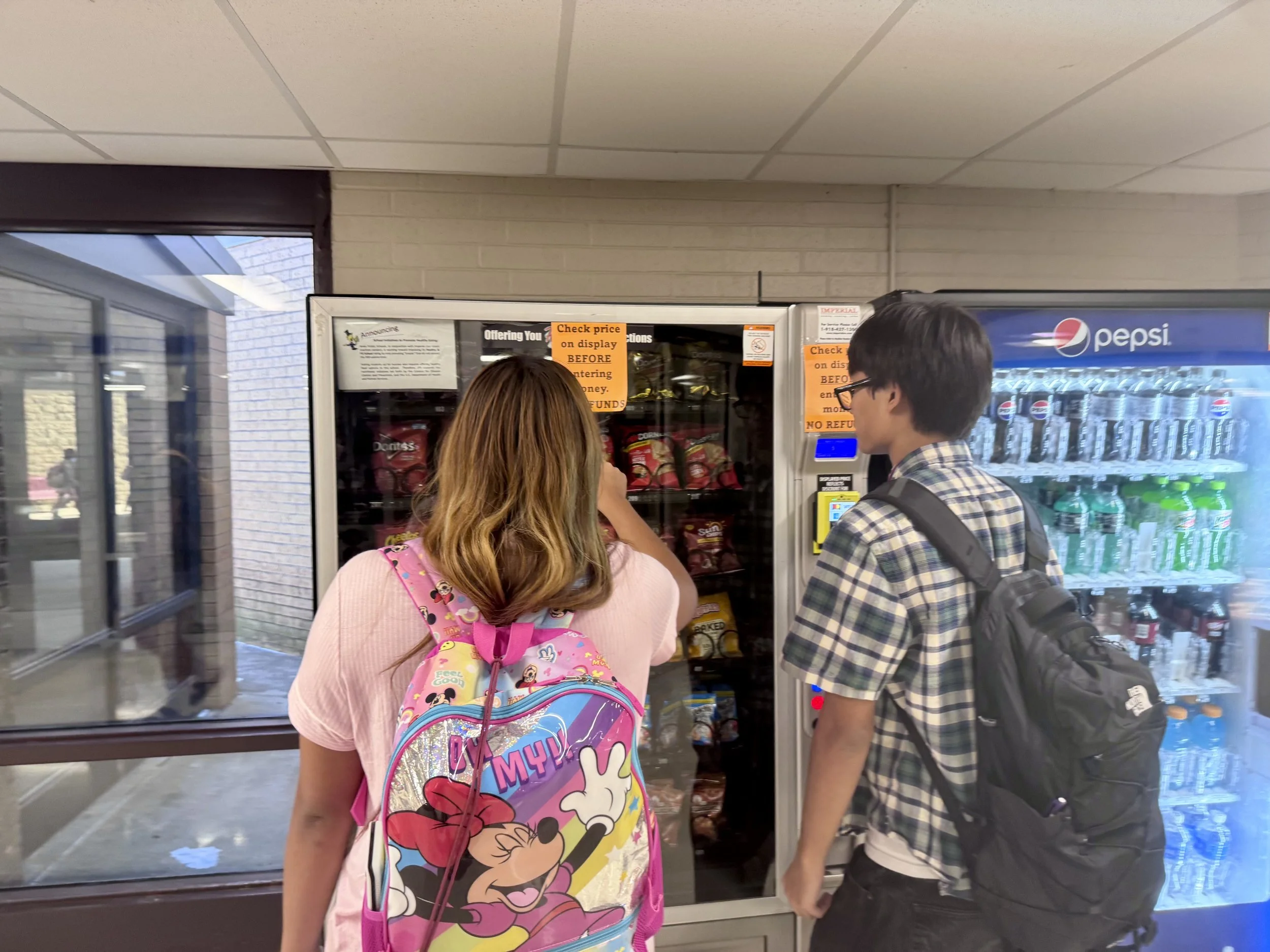 two students at a vending machine