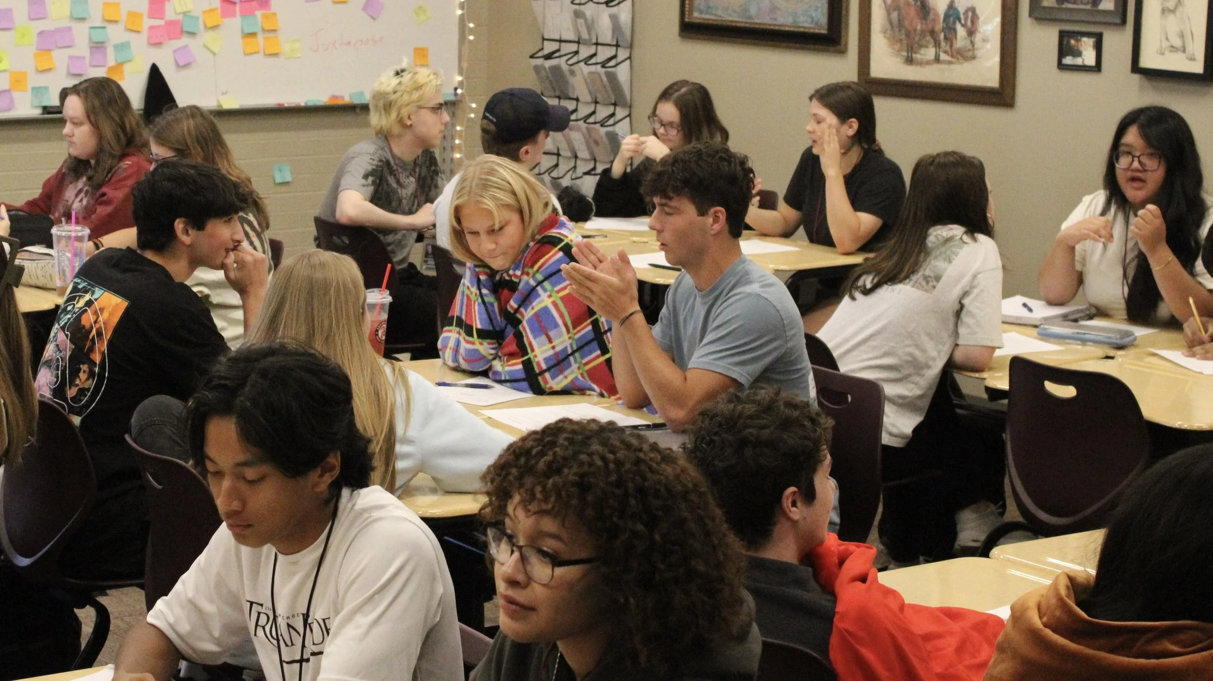 A class is engaged in small group discussions