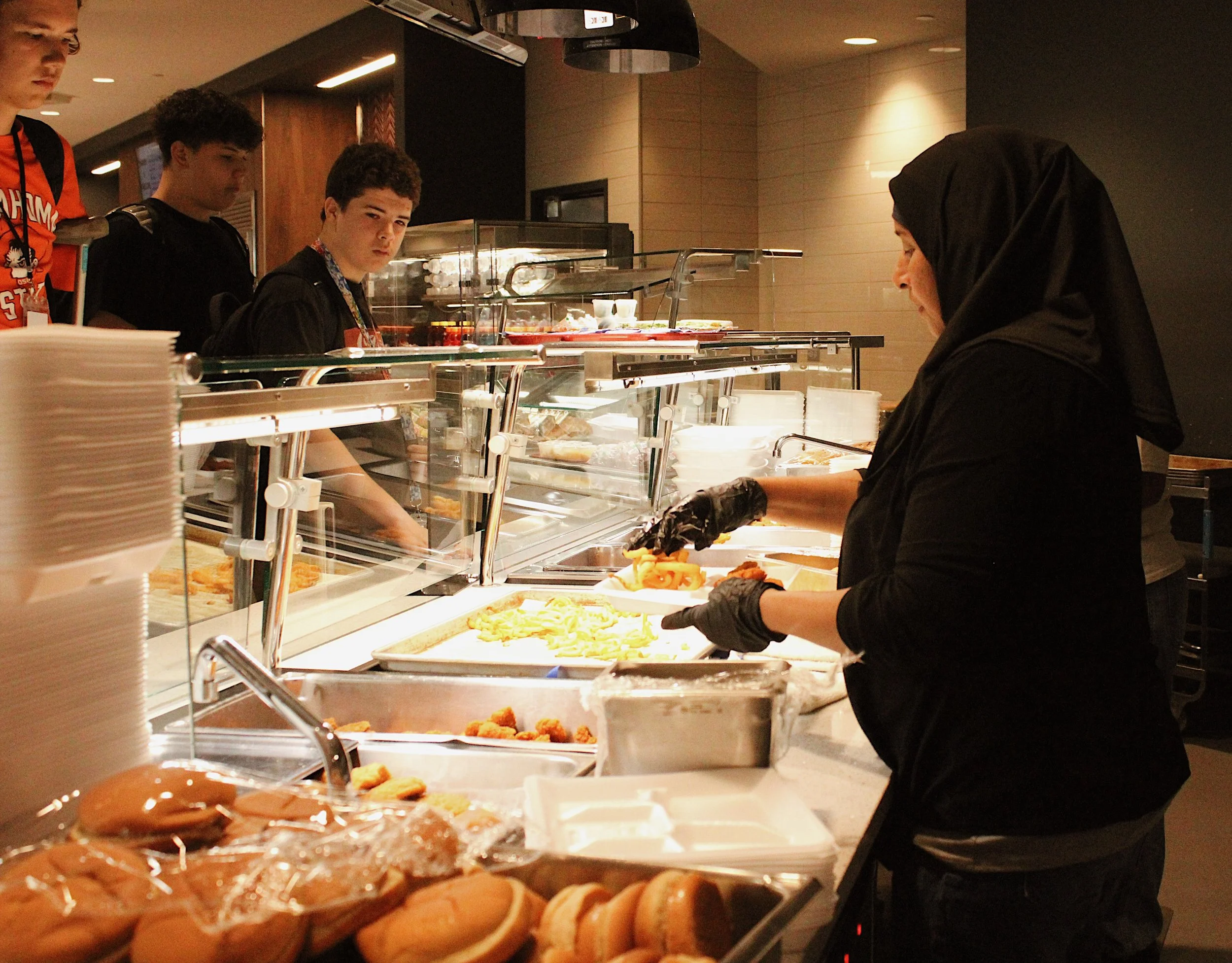 Cafeteria worker serving lunch