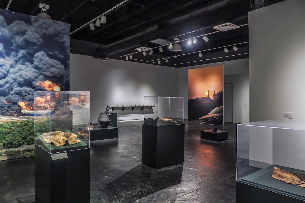 In the foreground are three Fireful of Fear sculptures (2008-2018). Background right: Coringa Drive on the Day the Woolsey Fire Started in 2018 , 2021; printed fabric with holes created while crushing inherited dinnerware; 108 x 144 inches