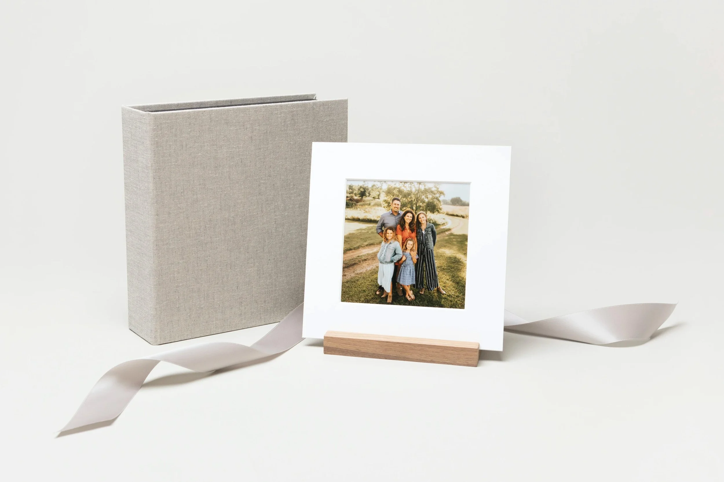 whcc_square-material-cover-image-box-white-matted-print-wood-display-stand_styled_holiday-ribbon.jpg