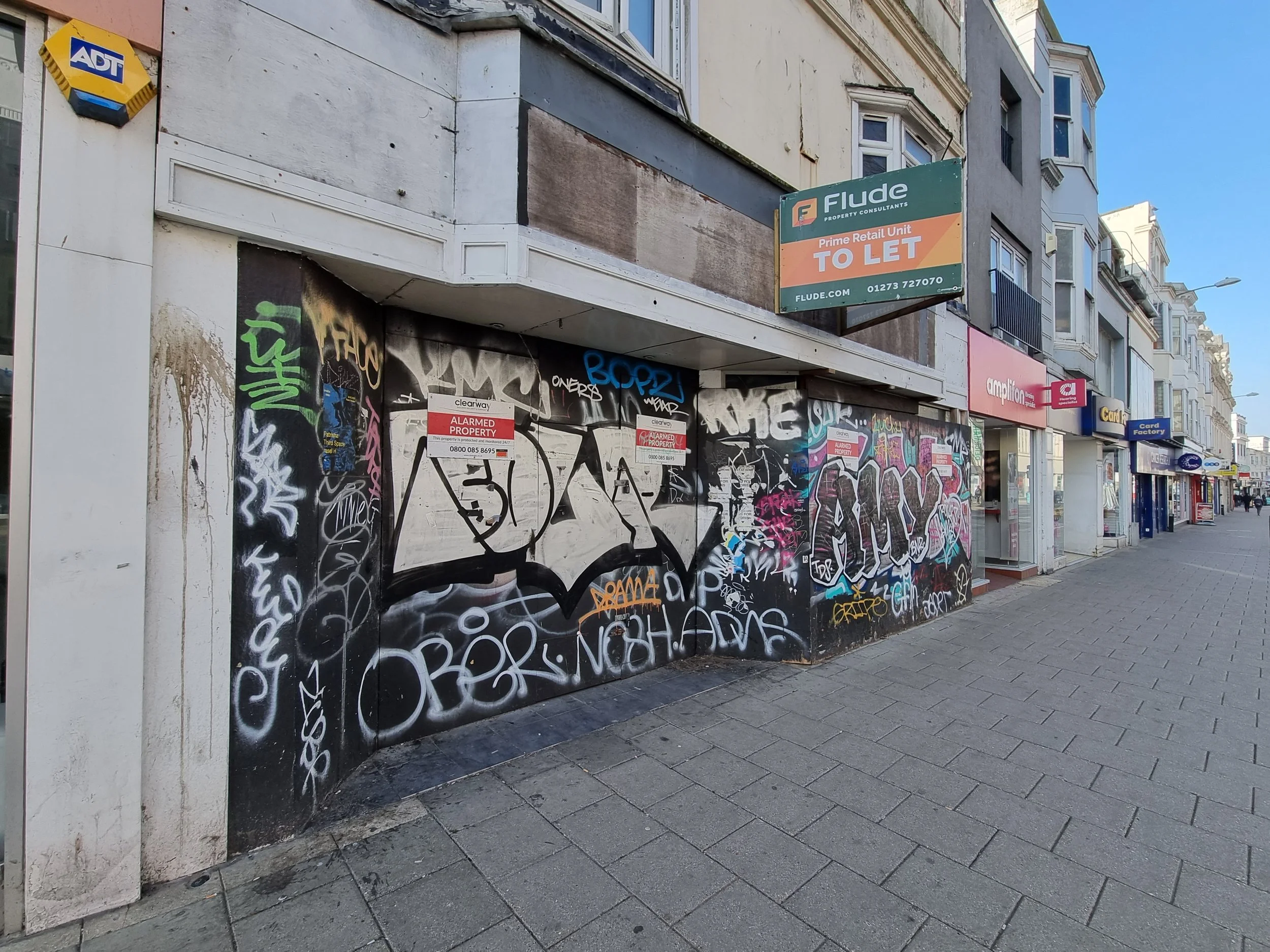 Abandoned building with graffiti over the top of the boards
