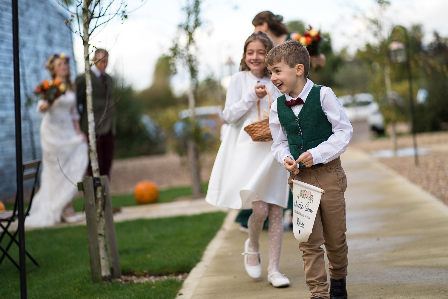 Page boy and flower girl make a happy entrance