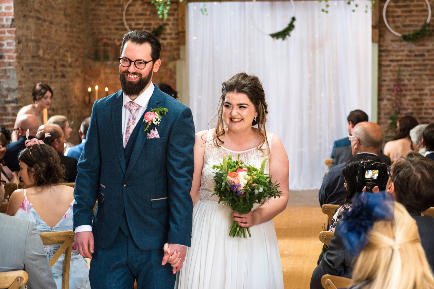 Bride and groom celebrate rustic wedding at The Barns East Yorkshire