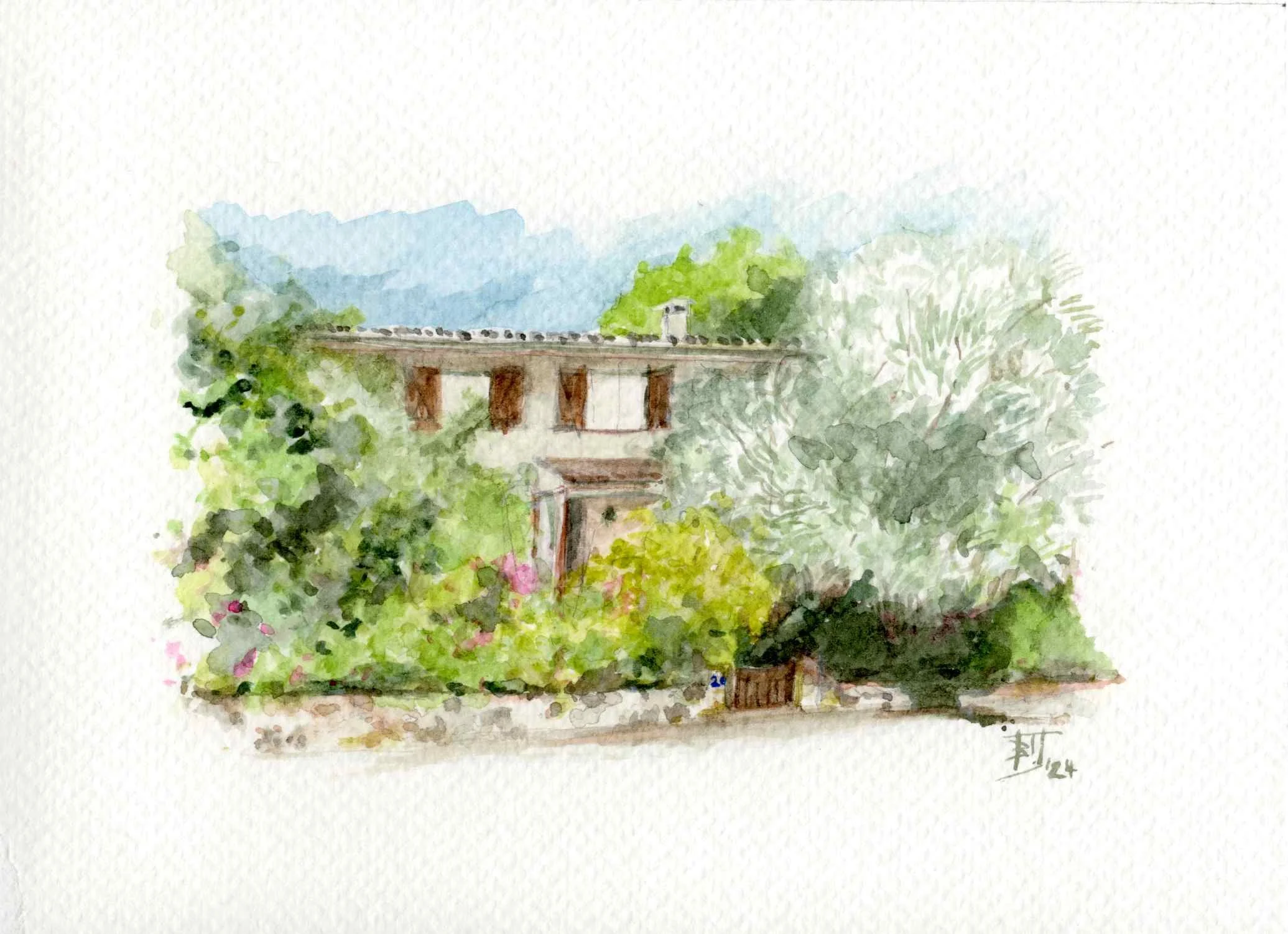A watercolor painting depicts a house or building with a grey roof and brown support beams, surrounded by lush green trees and plants. In the background, blue mountains and sky are visible.