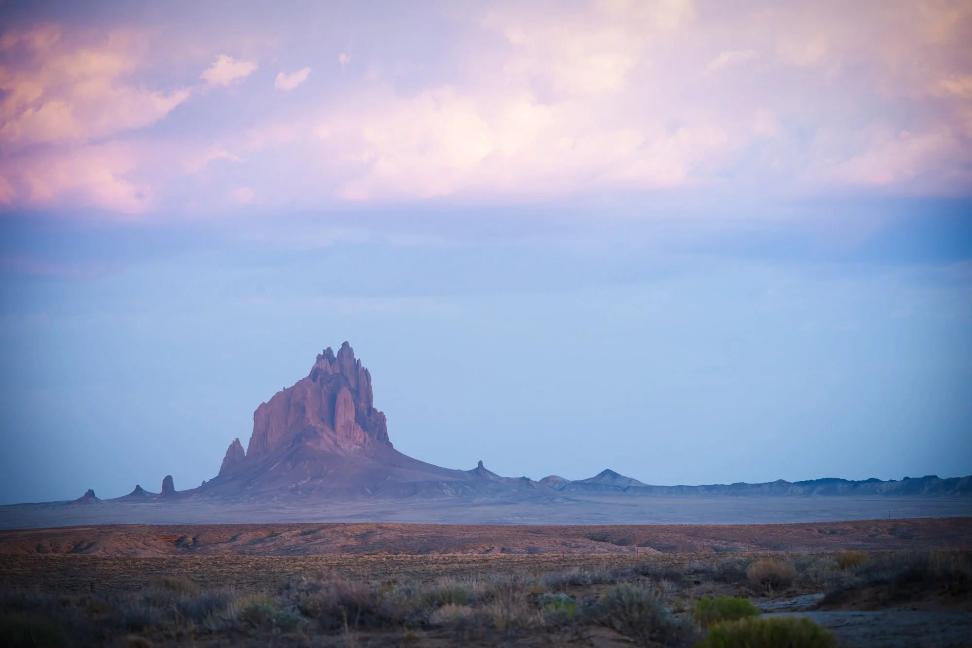 Agathla Peak, near Kayenta, Arizona. It was formed when magma hardened within a volcanic vent, and the softer surrounding rock eroded over a geologic period of time.