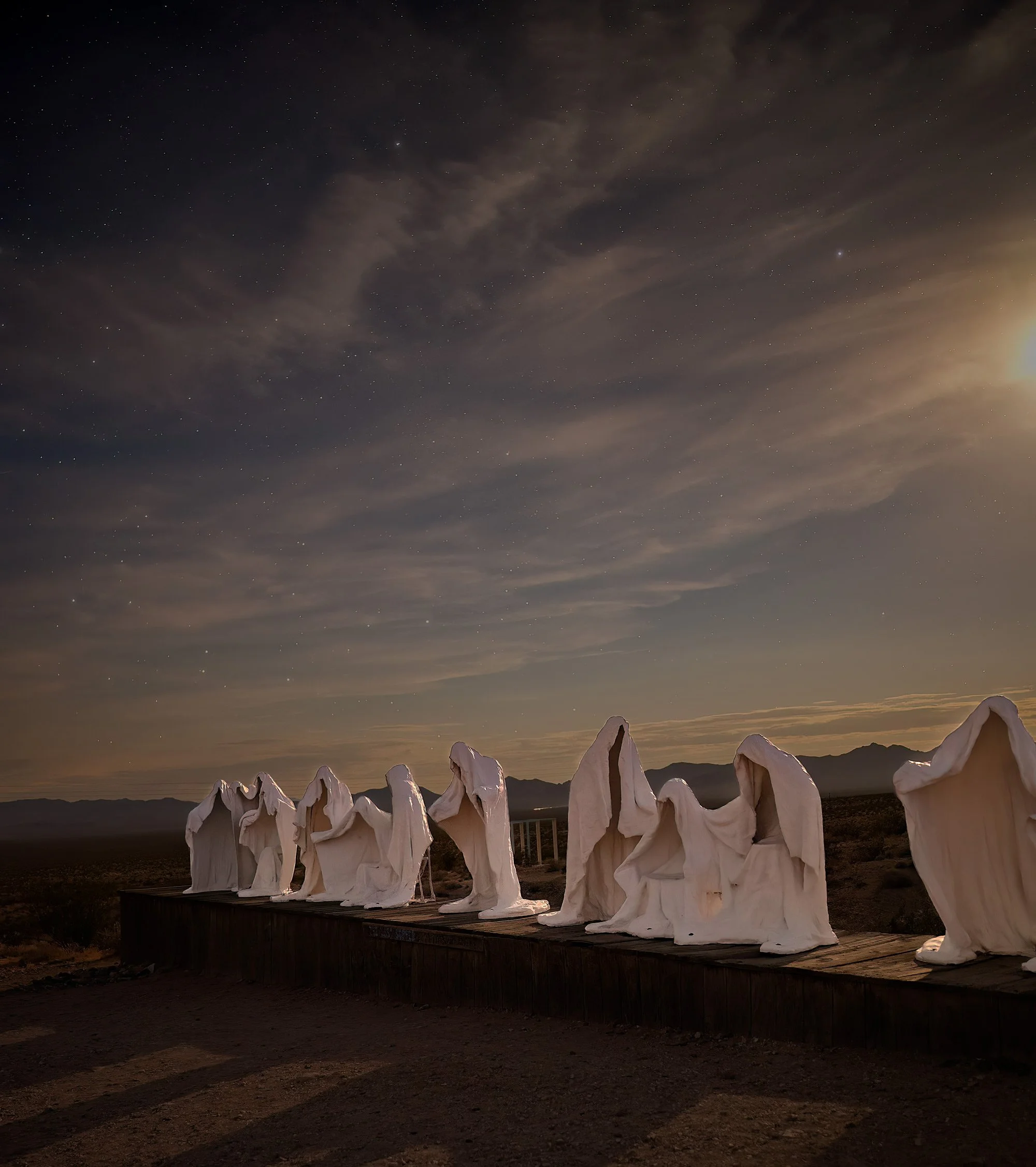 A scattering of stars emerges in the twilight over the ghost town of Rhyolite, Nevada, a gateway to Death Valley. The Belgian artist Albert Szukalski visited the ghost town of Rhyolite, Nevada for over a decade, creating sculptures and other artwork 