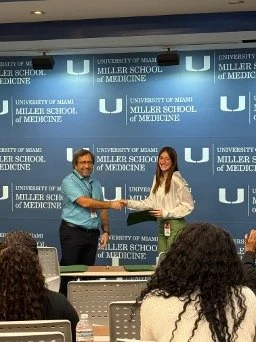 Sam receiving award for her SURF presentation