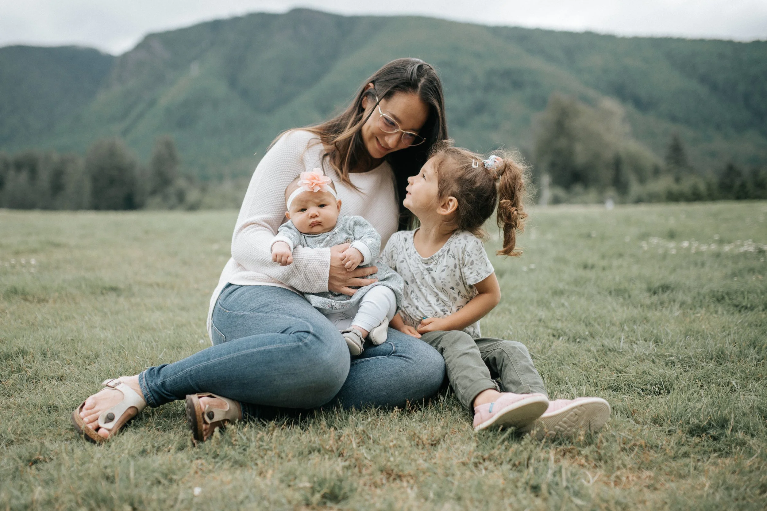Mother sitting outdoors with her children in Squamish, BC