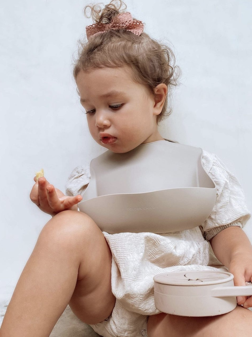 a toddler wearing in silicone bib
