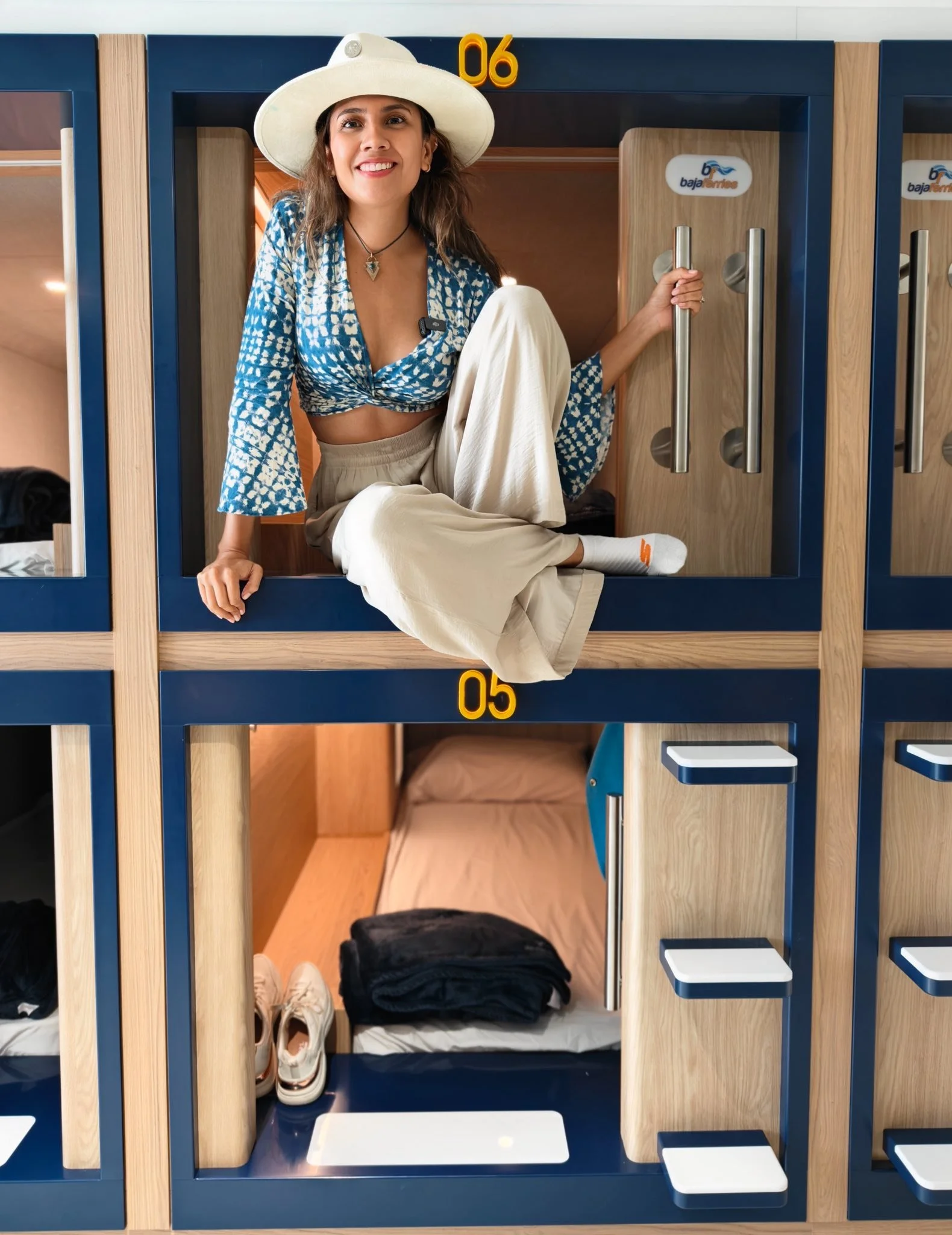 Guest using the Nautilus Sleeping Pod, illustrating a private capsule-style sleeping experience.