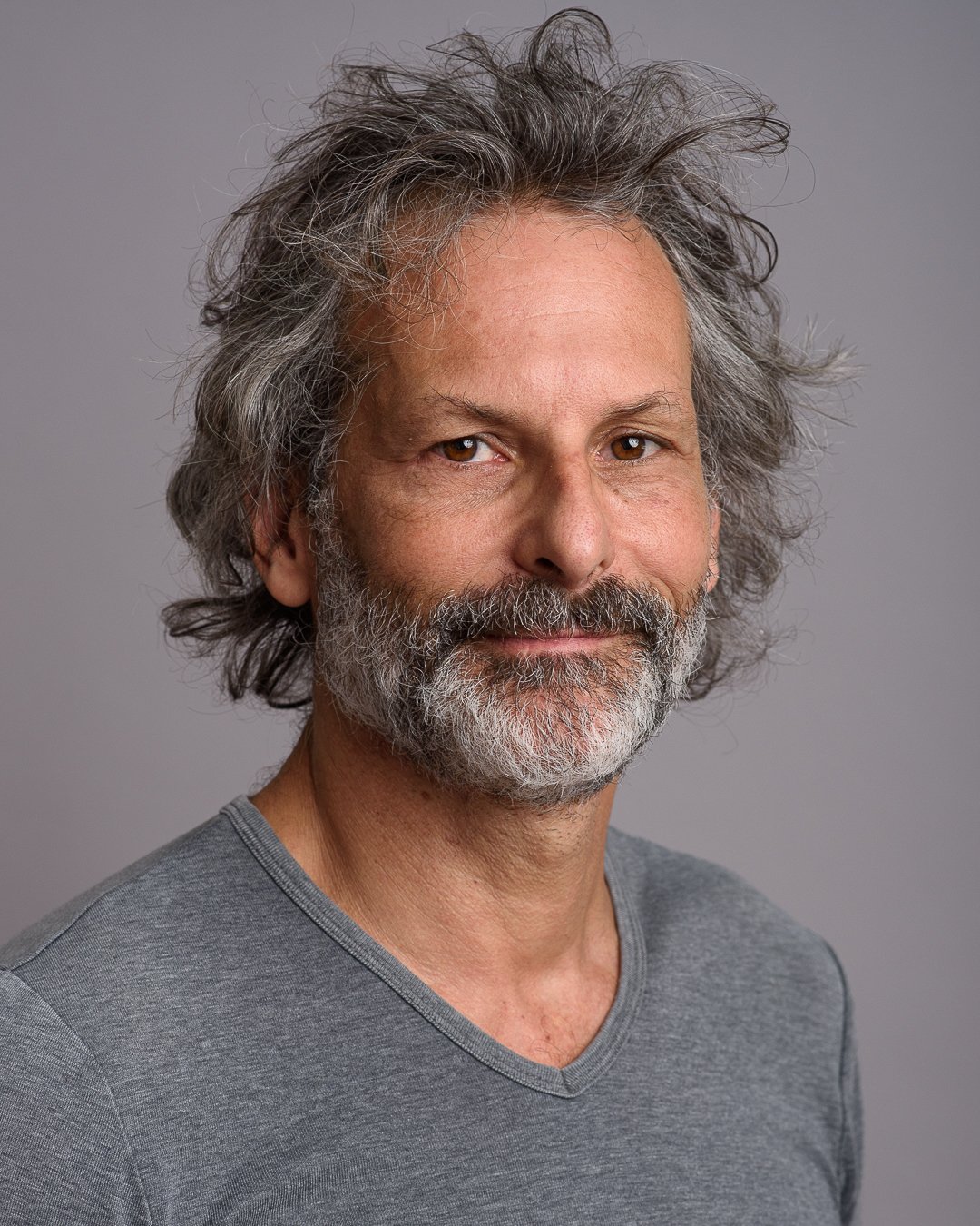 Cape Town entrepreneur headshot of Truth Coffee founder David Donde against a grey studio background.