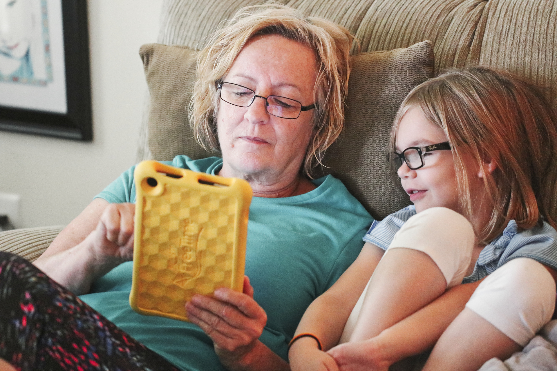 Image of a woman sitting on a couch with child. Image links to Licking County Job and Family Services Kinship Care page.