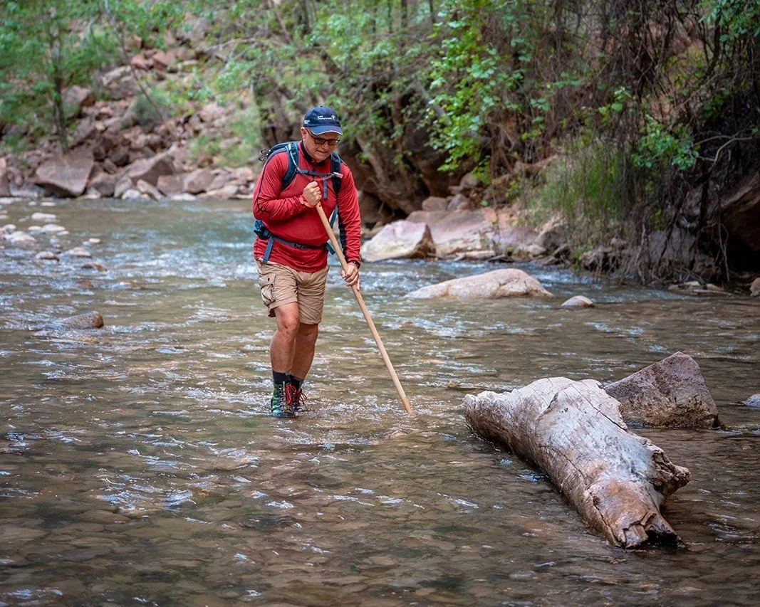 A man in red wades through the narrows in zion