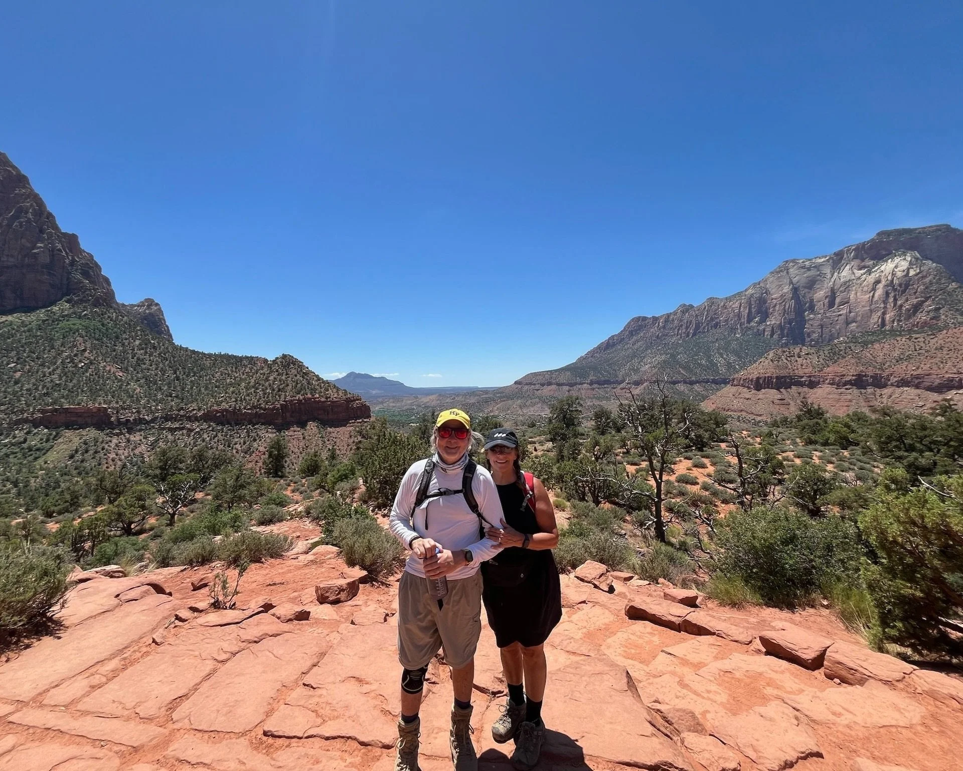 Two people in hats hiking in zion