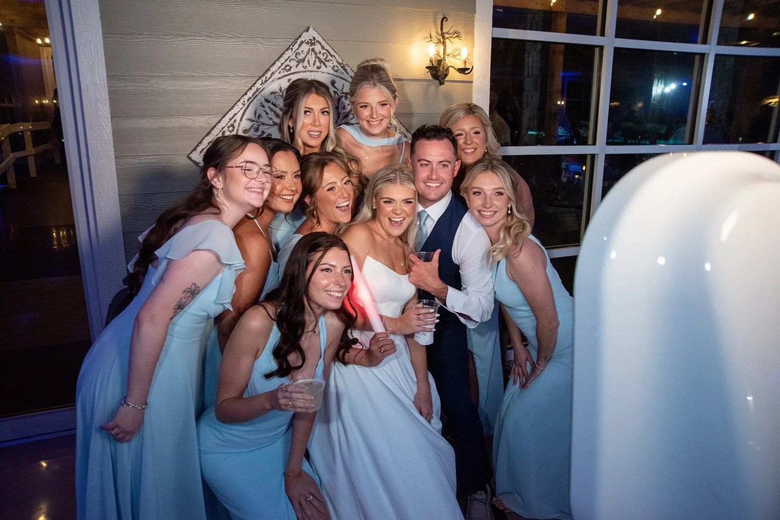 Cameron and Makenzie posing with bridal party at a fun photo booth.