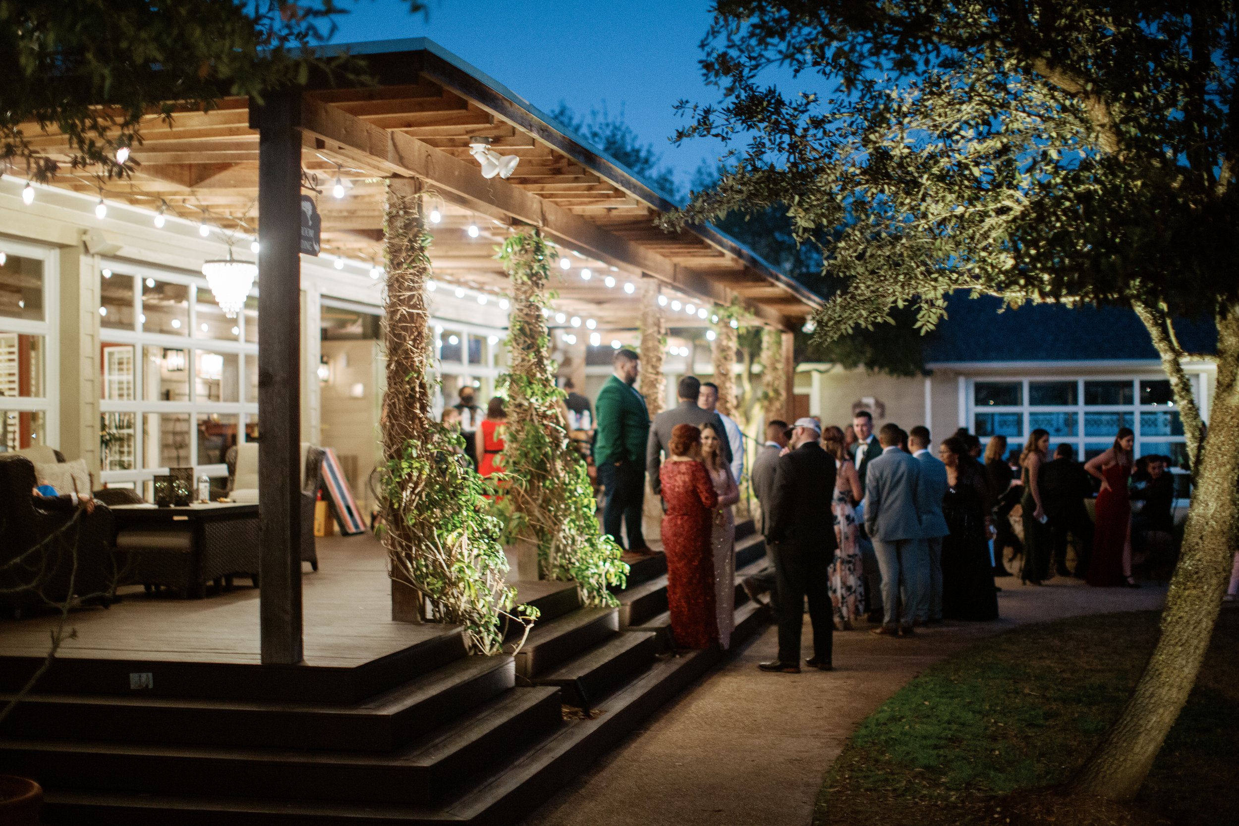 Wedding guests mingle under the covered outdoor gathering area at Inn at Quarry Ridge