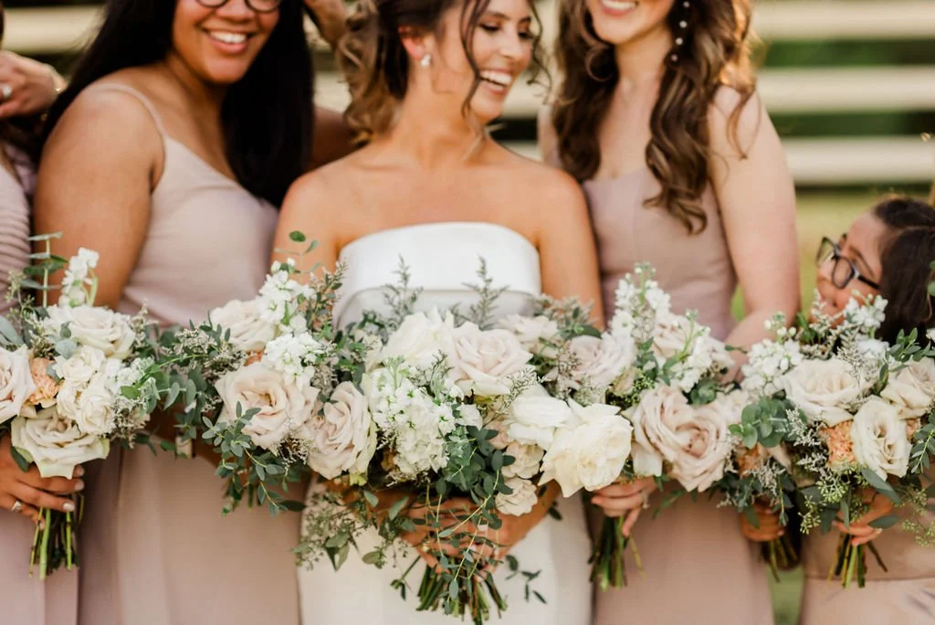 bride and bridesmaids show their florals