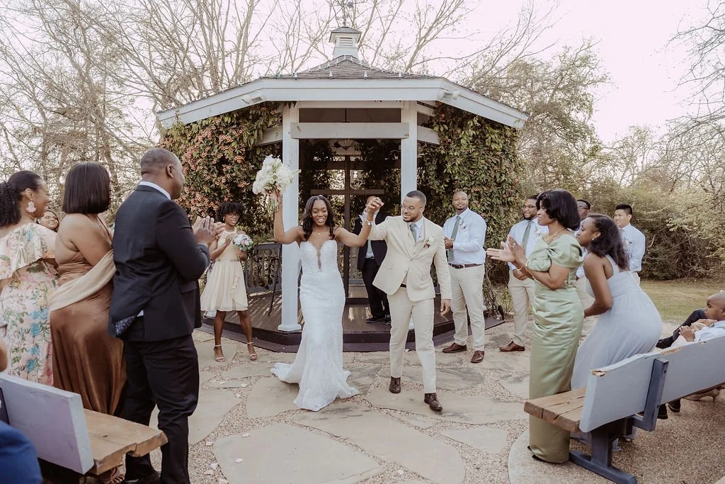 Bride and groom take their first walk down the isle as husband and wife in outdoor ceremony