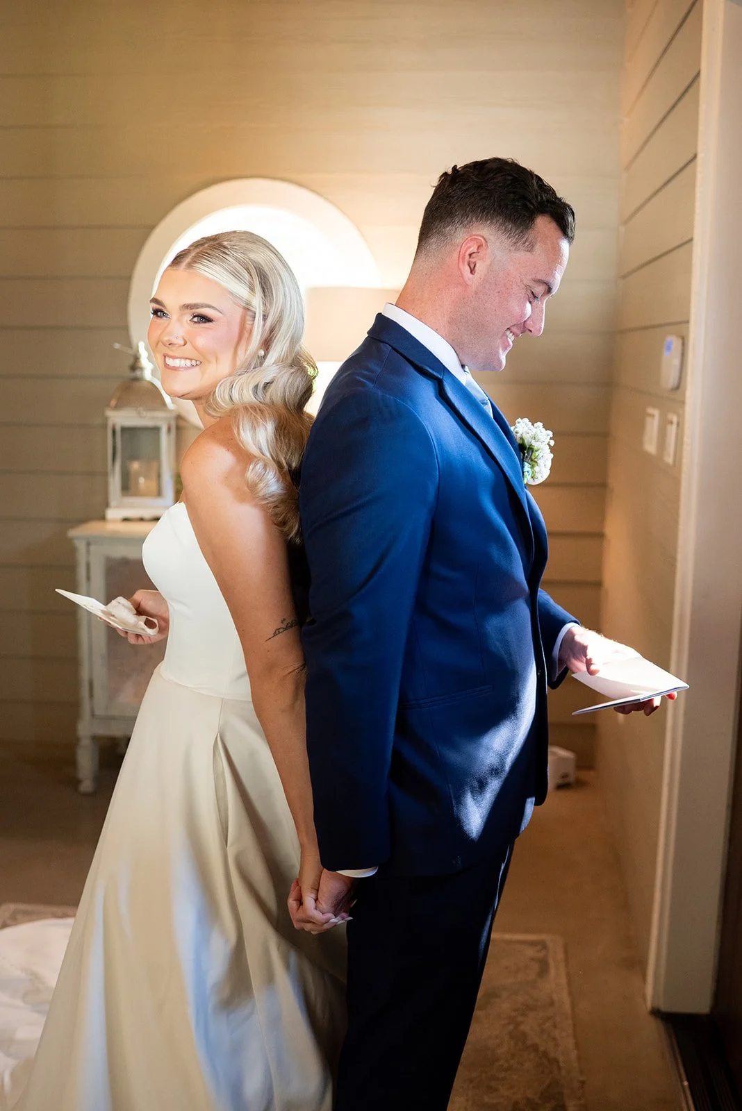 Cameron and Makenzie standing back to back as they read letters to each other before their ceremony.