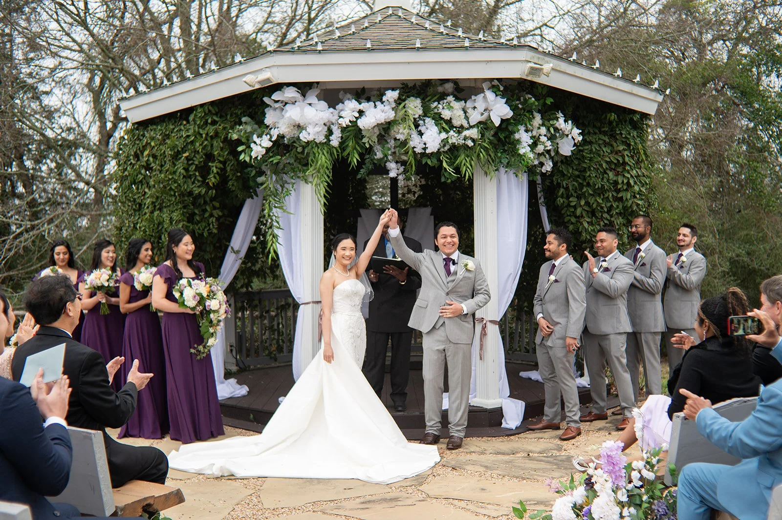 Outdoor wedding ceremony space surrounded by trees and greenery