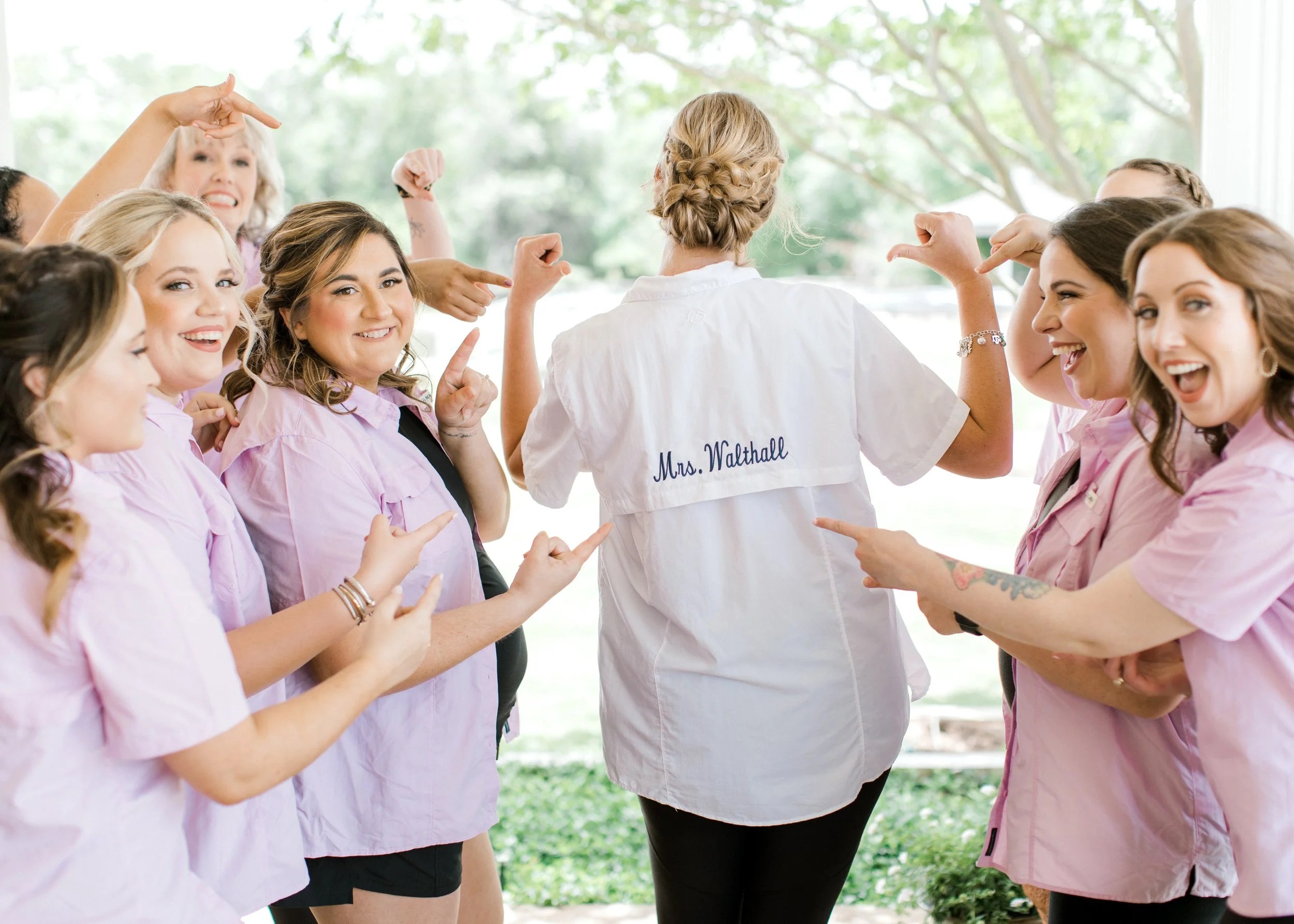 Mrs. Walthall shows off her custom shirt with her bridal party before getting ready for her ceremony