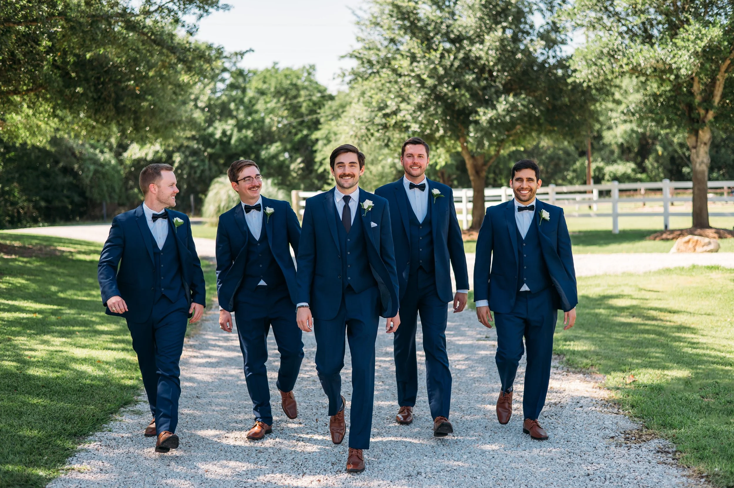 Groom and groomsmen take photos around the grounds of the Inn at Quarry Ridge