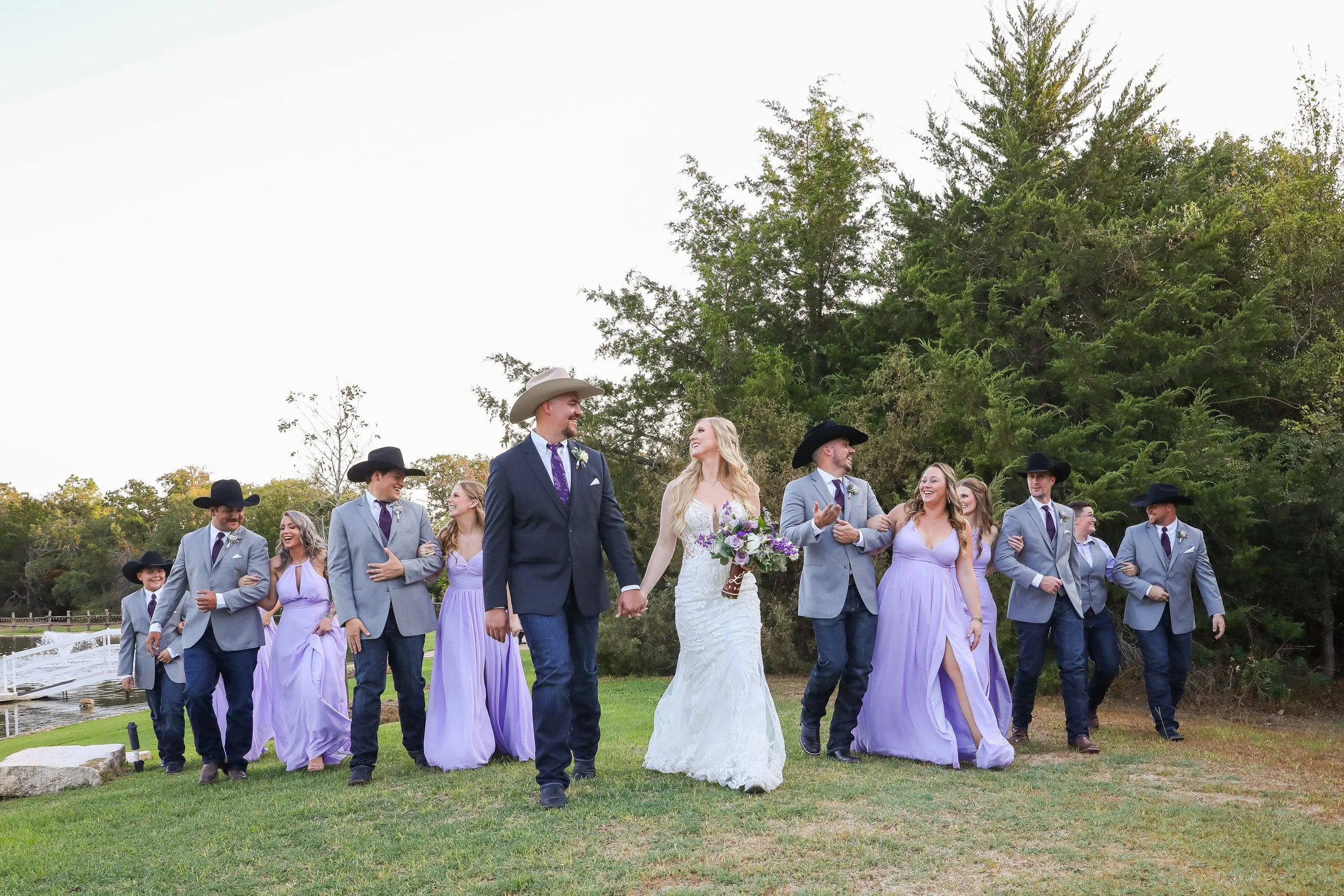 Bride, groom and their wedding party want around the scenic grounds of Inn at Quarry Ridge