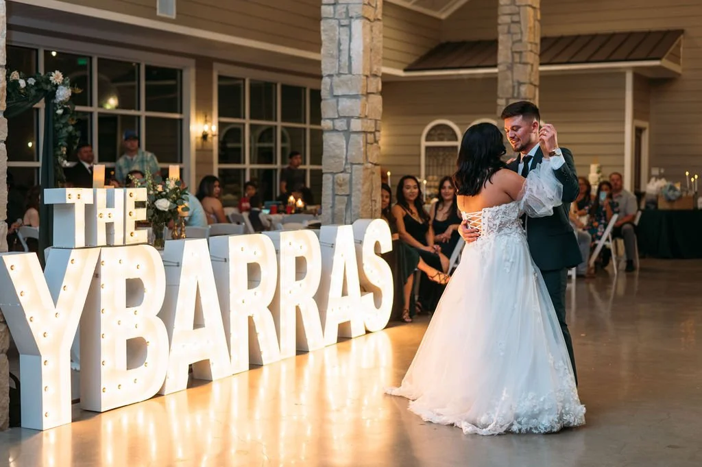 The Ybarras share their first dance at their reception in Stonehem Hall in Bryan Tx