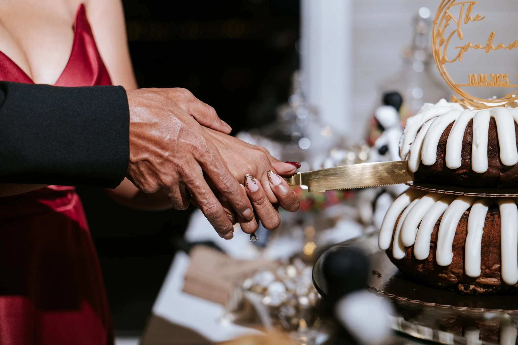 Couple cuts their wedding cake during their wedding reception