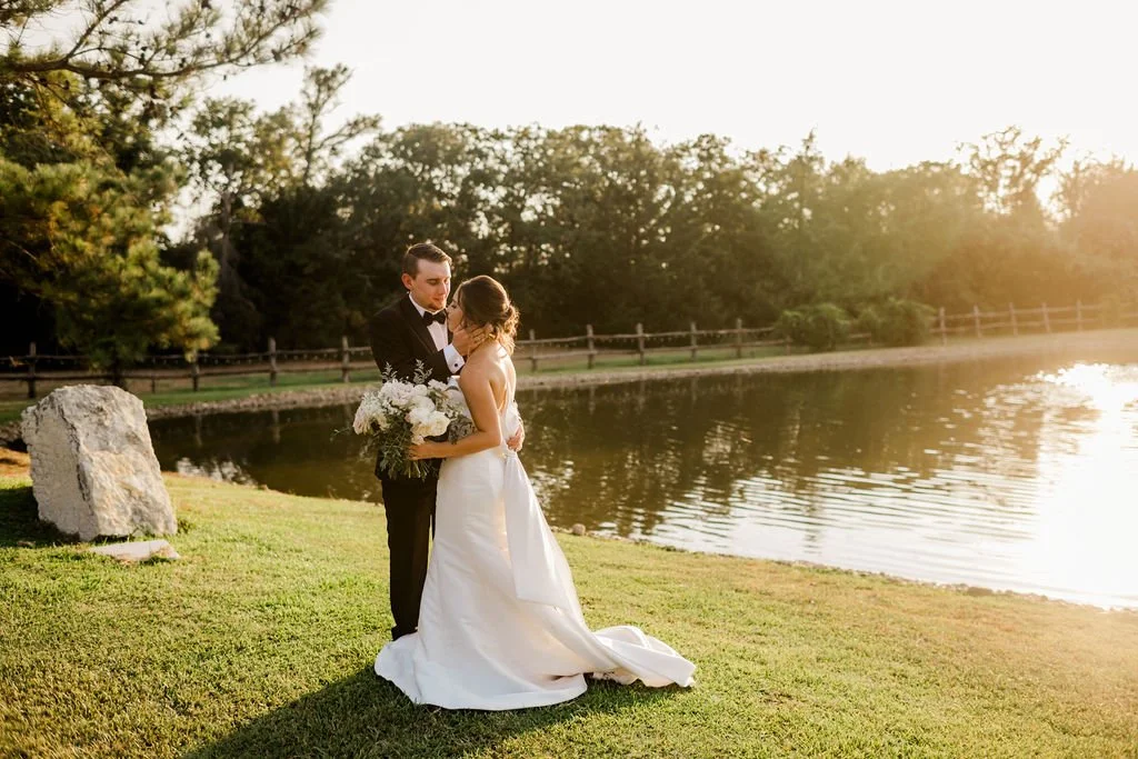 Bride and groom sharing a private moment lakeside at the Inn at Quarry