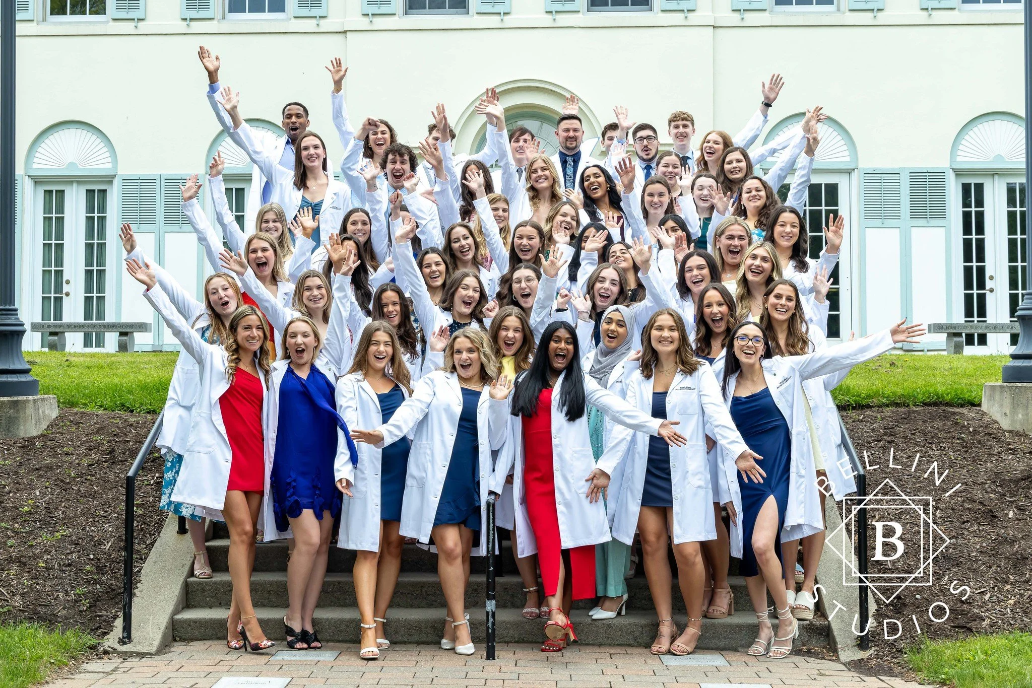University students celebrating at a white coat ceremony photographed by Bellini Studios