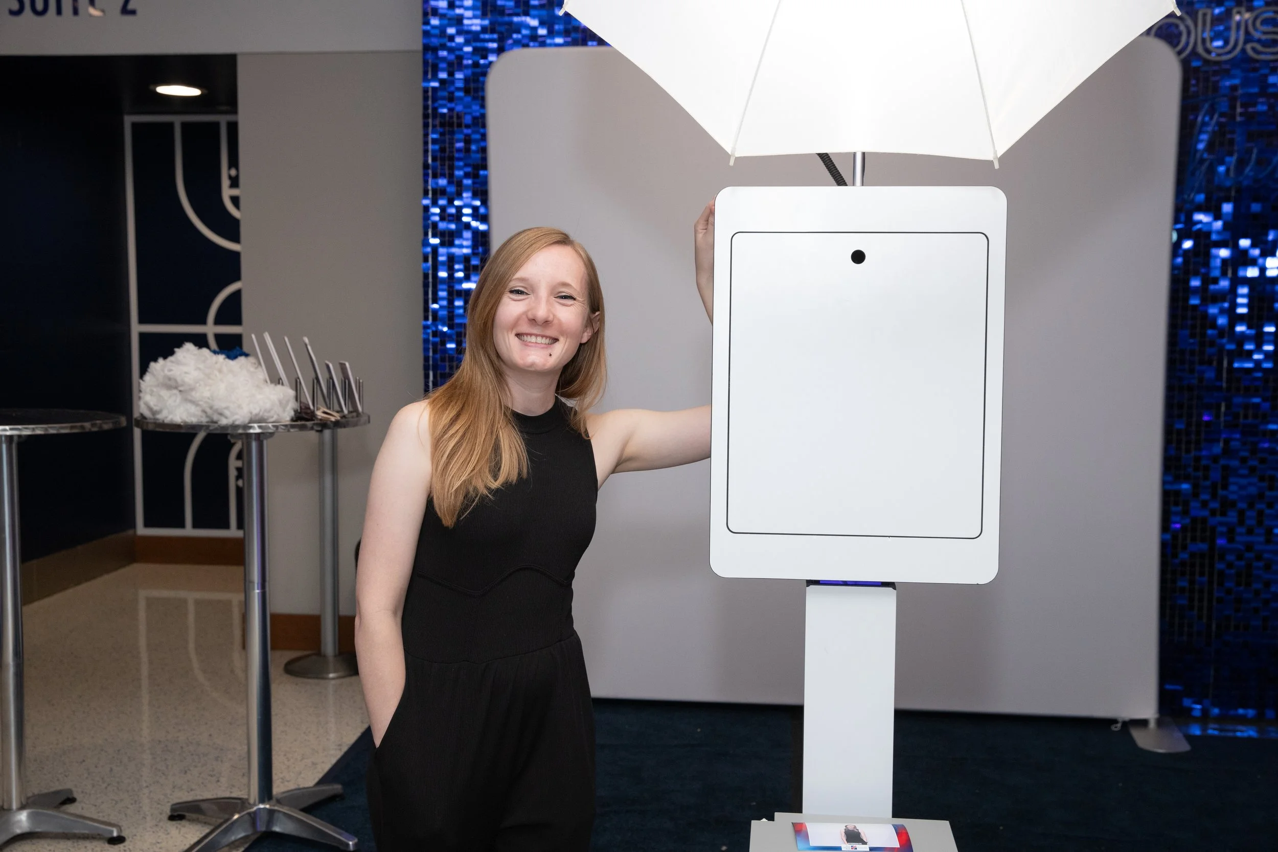 Woman poses with Trading Card Photo Booth at basketball arena in OKC