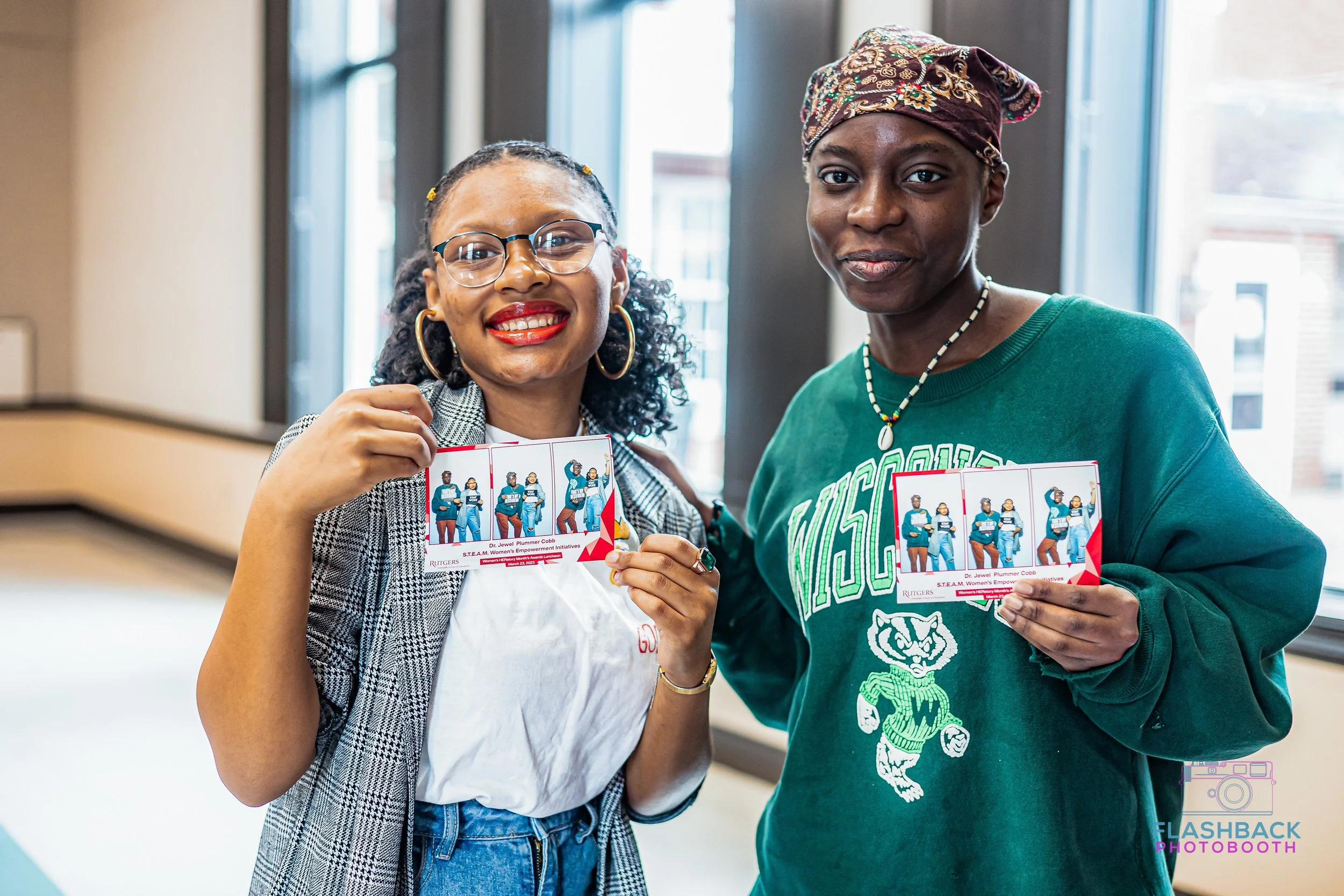 College students posing with prints from photob booth in OKC