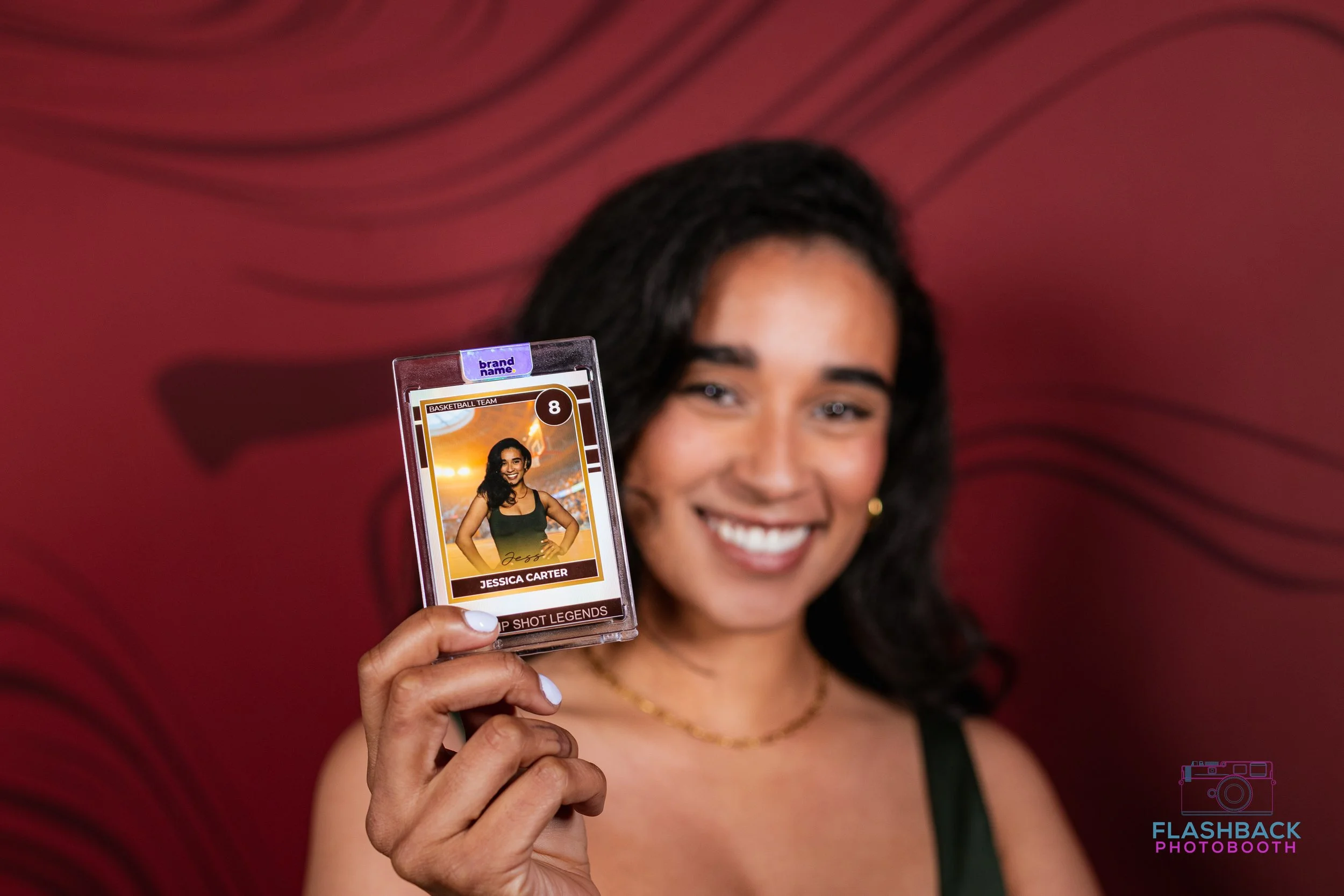 Woman holding photo booth trading card in OKlahoma City